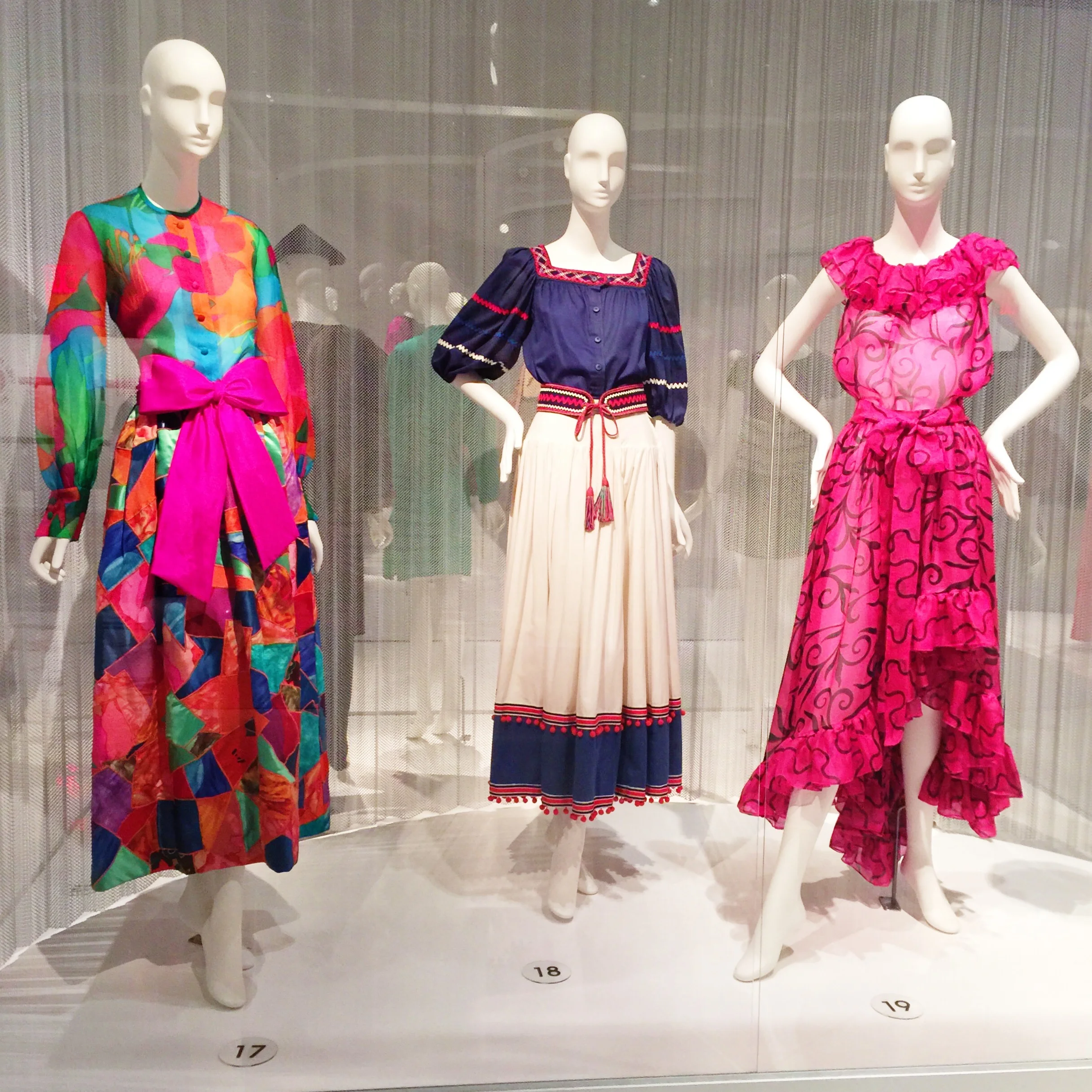 Left to Right Yves Saint Laurent Patchwork evening ensemble, silk organza, satin, and taffeta, 1969, Paris Saint Laurent Rive Gauche Red, white, and blue "peasant" ensemble, cotton, 1977, France Fuchsia "Spanish" ensembe, printed chiffon, 1978, France