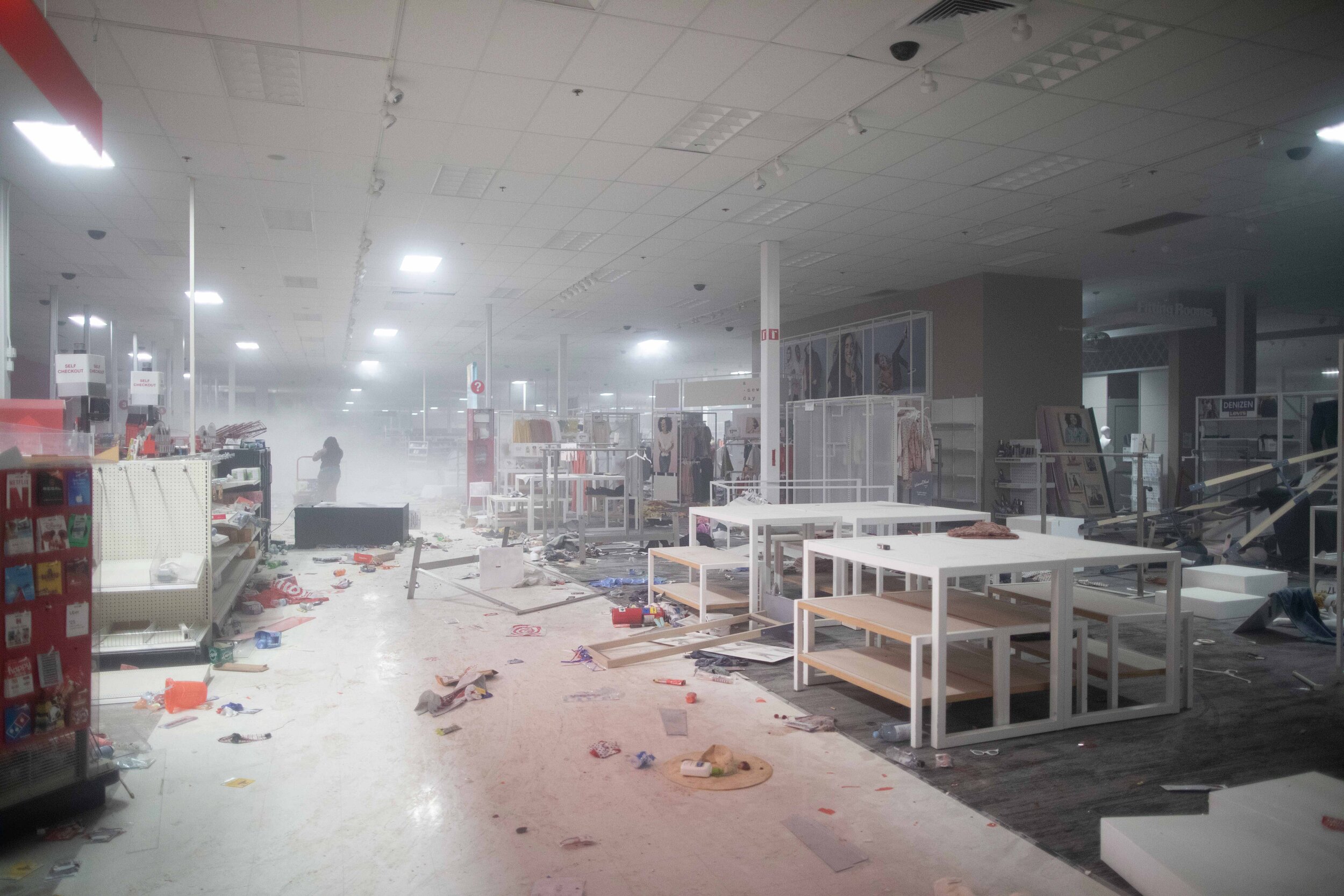  Remnants of tear gas still fills the air as looters clear out a Target store in Minneapolis, Minnesota. Protests turned into riots with looting of businesses overnight over the police killing of George Floyd on May 27. 