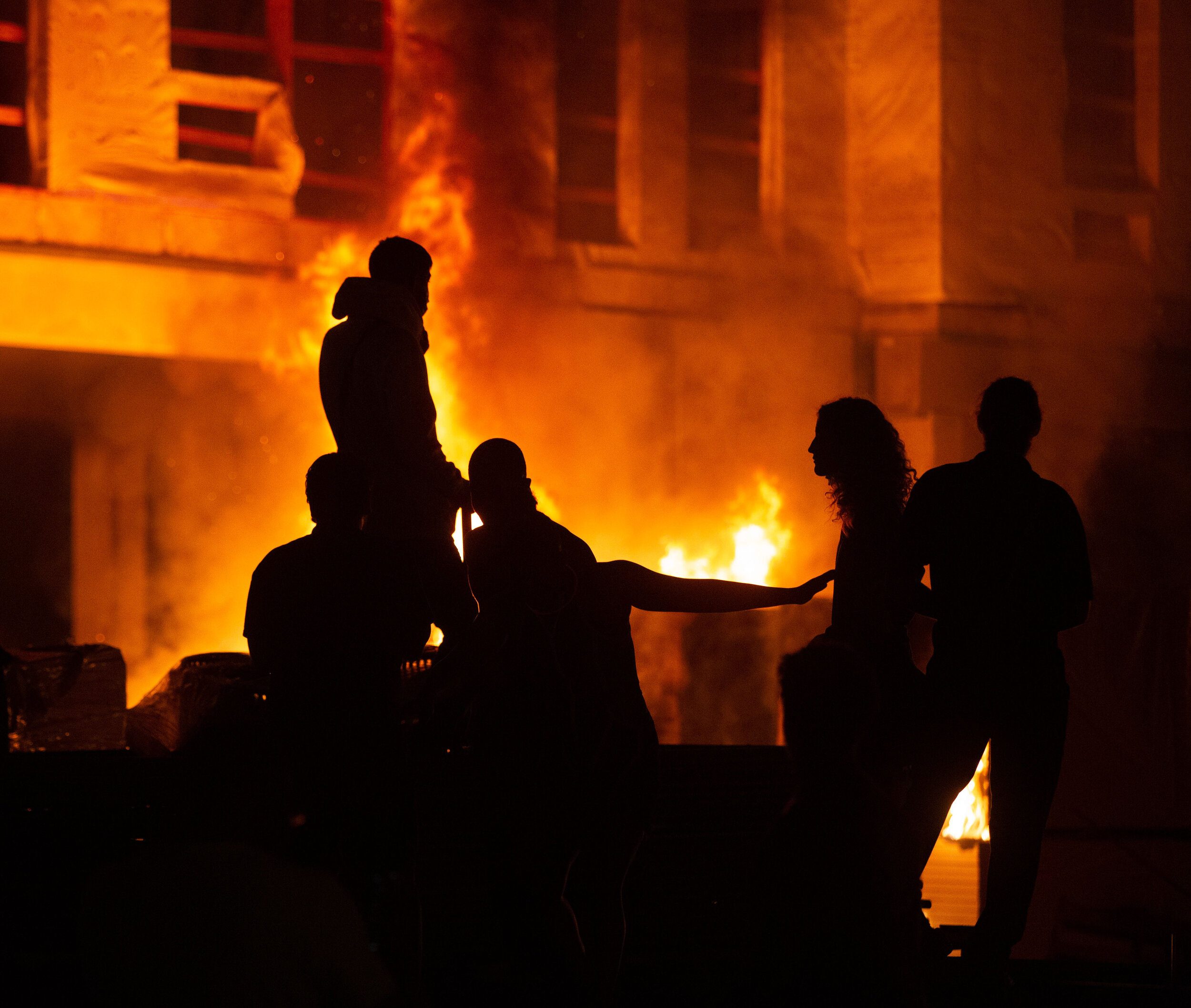  After a construction site was set on fire during riots in Minneapolis, Minnesota over the police killing of George Floyd, protesters congregate on the site on May 27. 