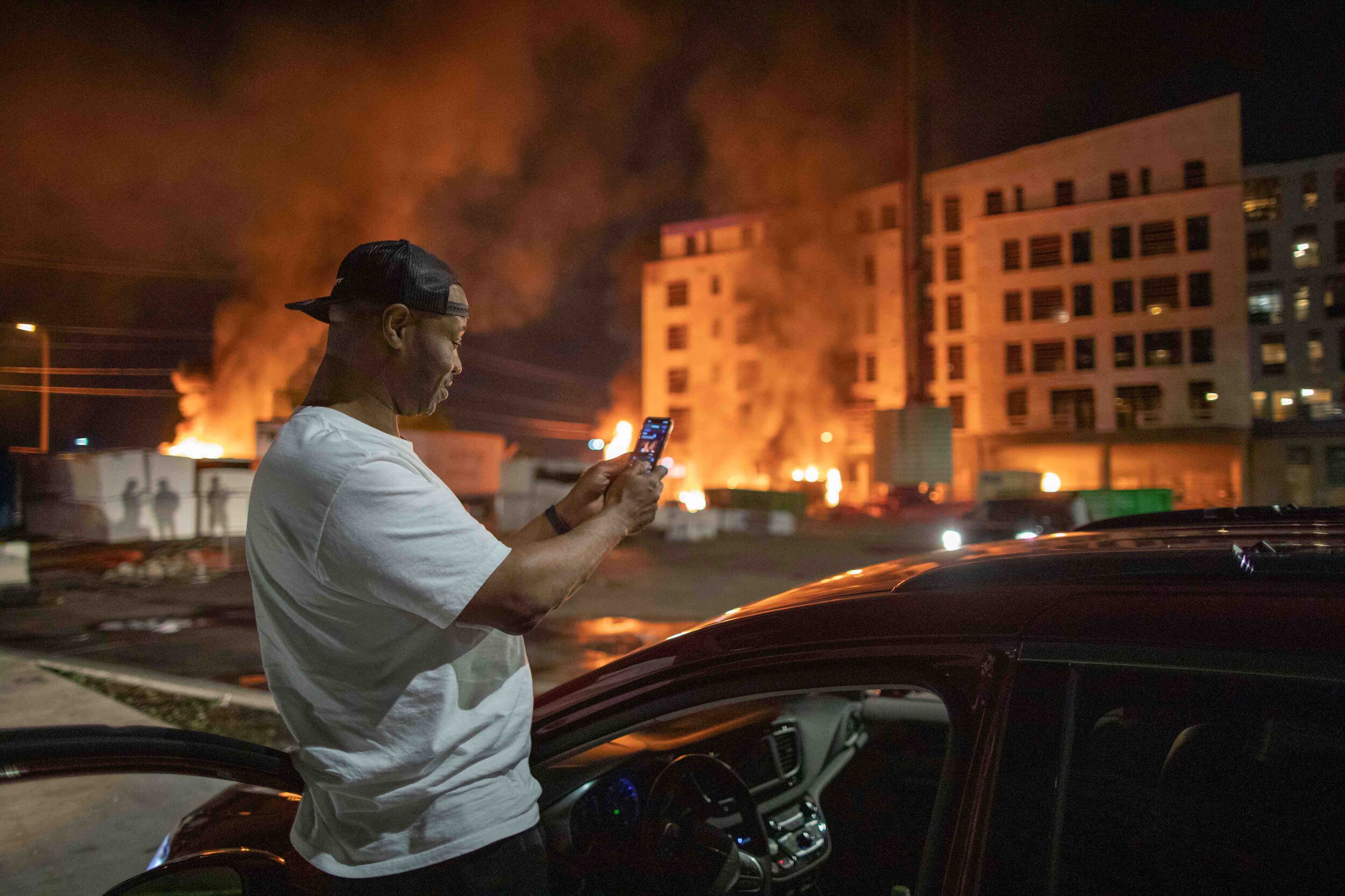  As a construction site burns in front of him, Jeff films what was happening from his vehicle after it was set on fire during a riot over the police killing of Geroge Floyd in Minneapolis, Minnesota on May 27. 
