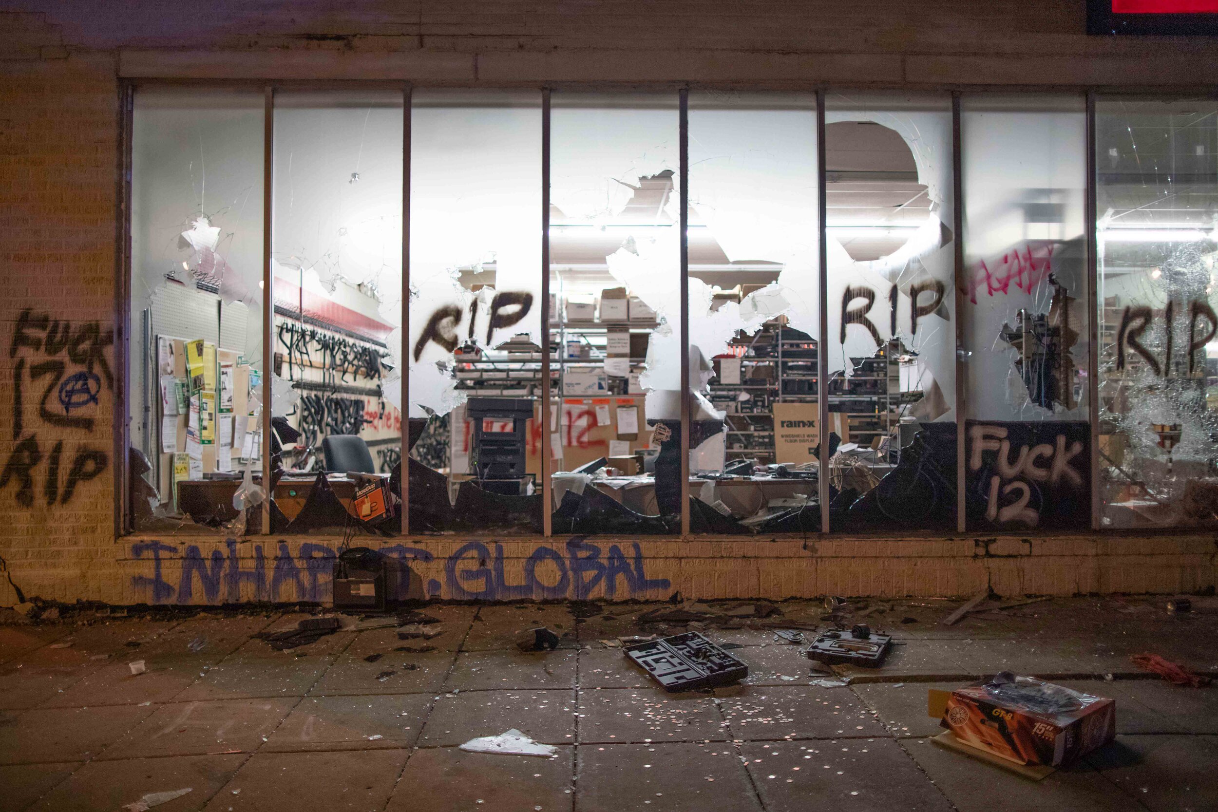  The windows of an O'Reily Auto Parts in Minneapolis sit mostly shattered with graffiti on parts of it. Looters broke into the store during a riot over the police killing of George Floyd in Minneapolis, Minnesota on May 28. 