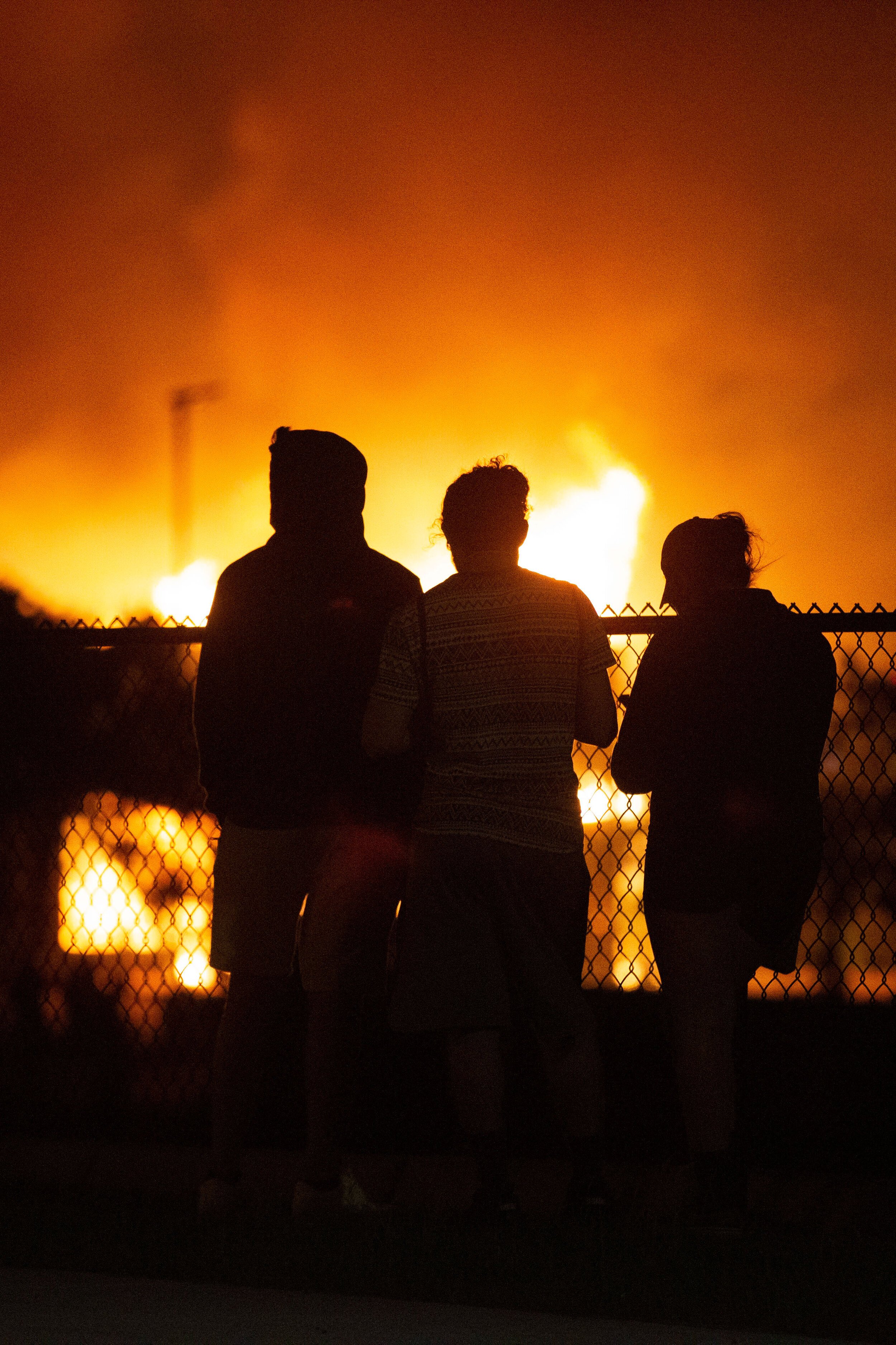  Protesters watch fires that burn which were set by protesters during riots over the police killing of George Floyd in Minneapolis, Minnesota on May 29, 2020. 