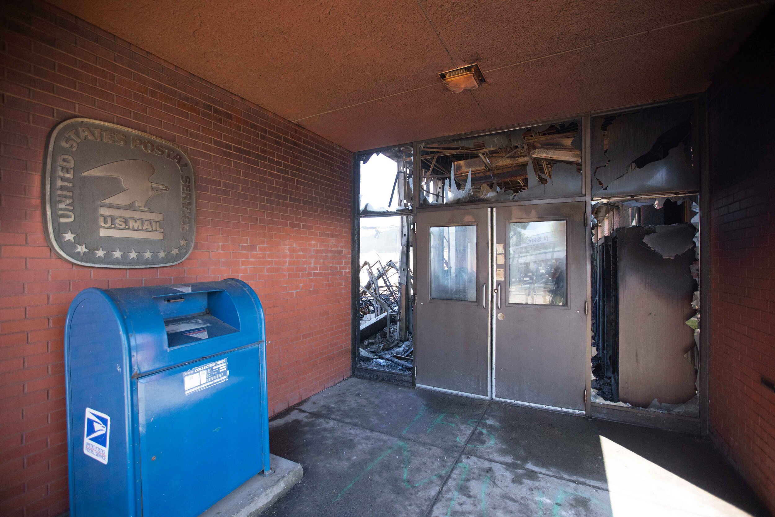  The entrance to a burned out postal offfive sits untouched by a fire that took most of the building out after riots broke out in Minneapolis, Minnesota over the police killing of George Floyd on May 30, 2020. Chris Juhn/Zuma. 