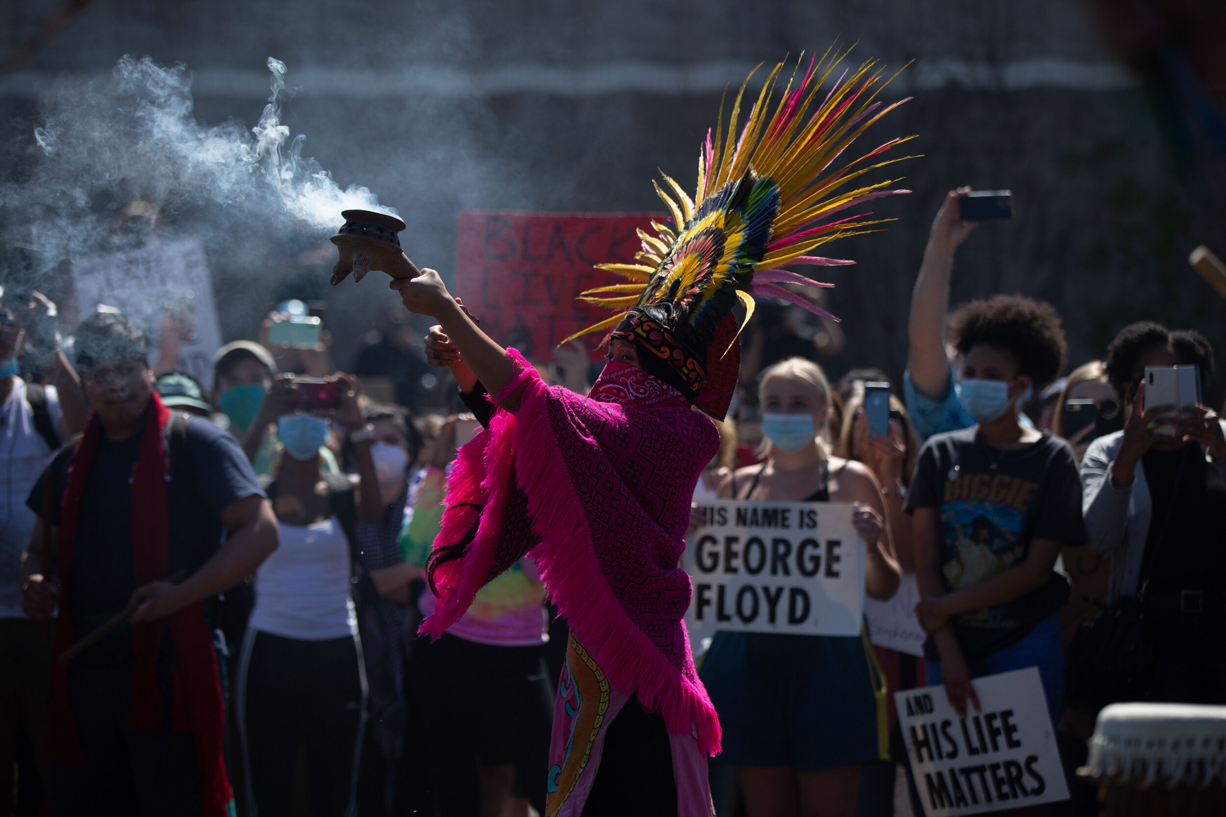 An Aztec dancer burns sage during a protest over the police killing of George Floyd in Minneapolis, Minnesota on May 30, 2020. Chris Juhn/Zuma. 