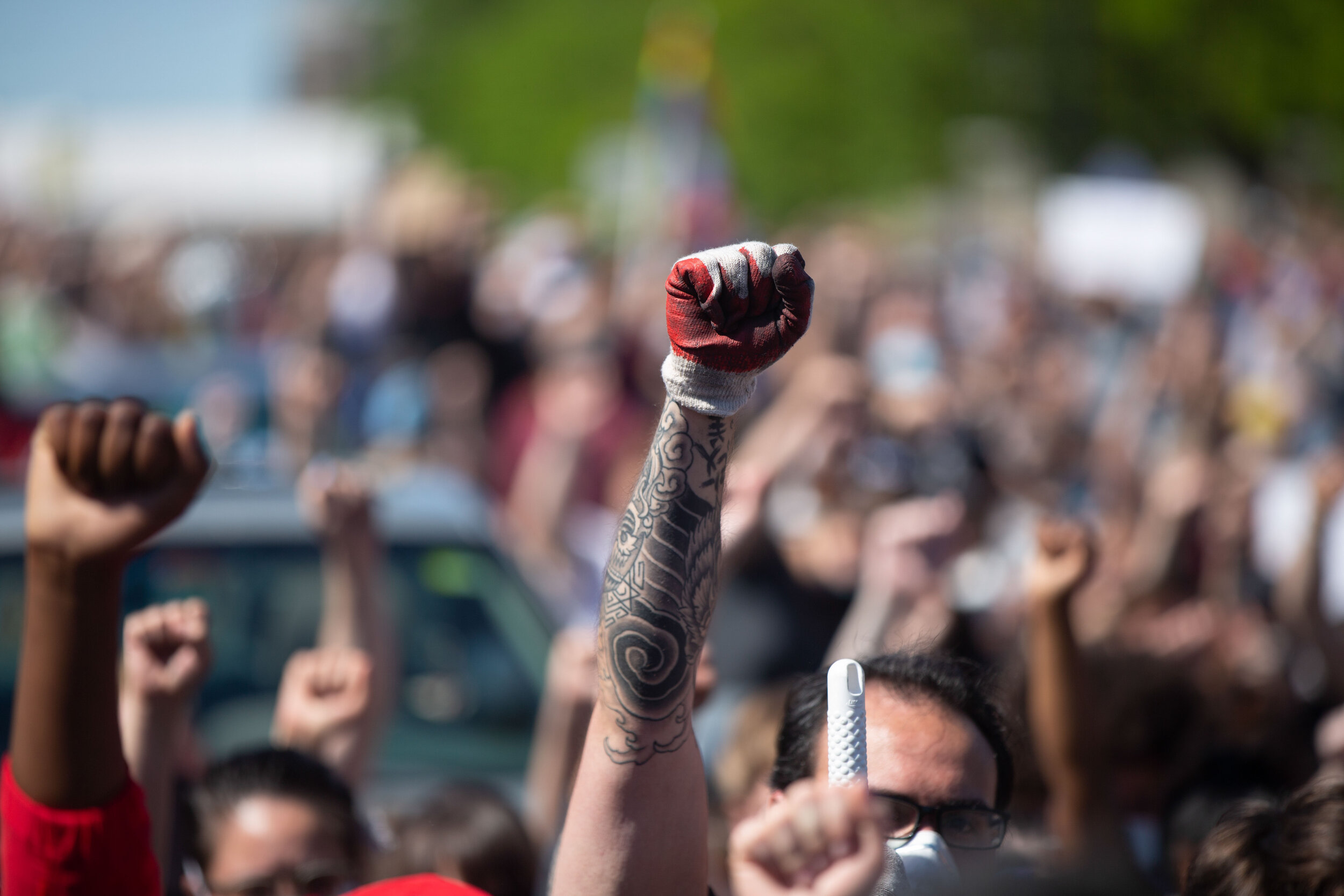  A man pits his fist in the air during a protest over the police killing of Geroge Floyd on May 30, 2020. Chris Juhn/Zuma. 