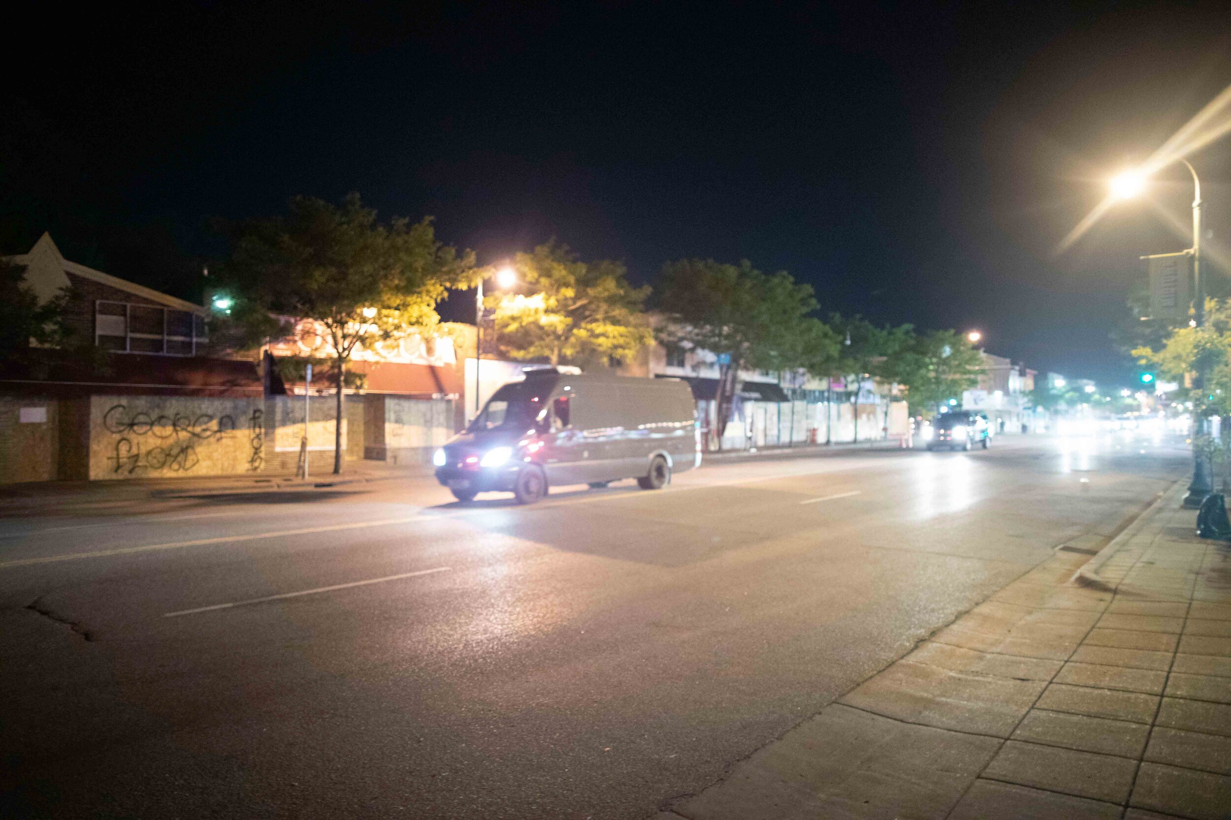  Police and National Guard vehicles drive down Lake Street in Minnepolis where they planned to arrest those breaking curfew in Minneapolis, Minnesota on May 30, 2020. Chris Juhn/Zuma. 