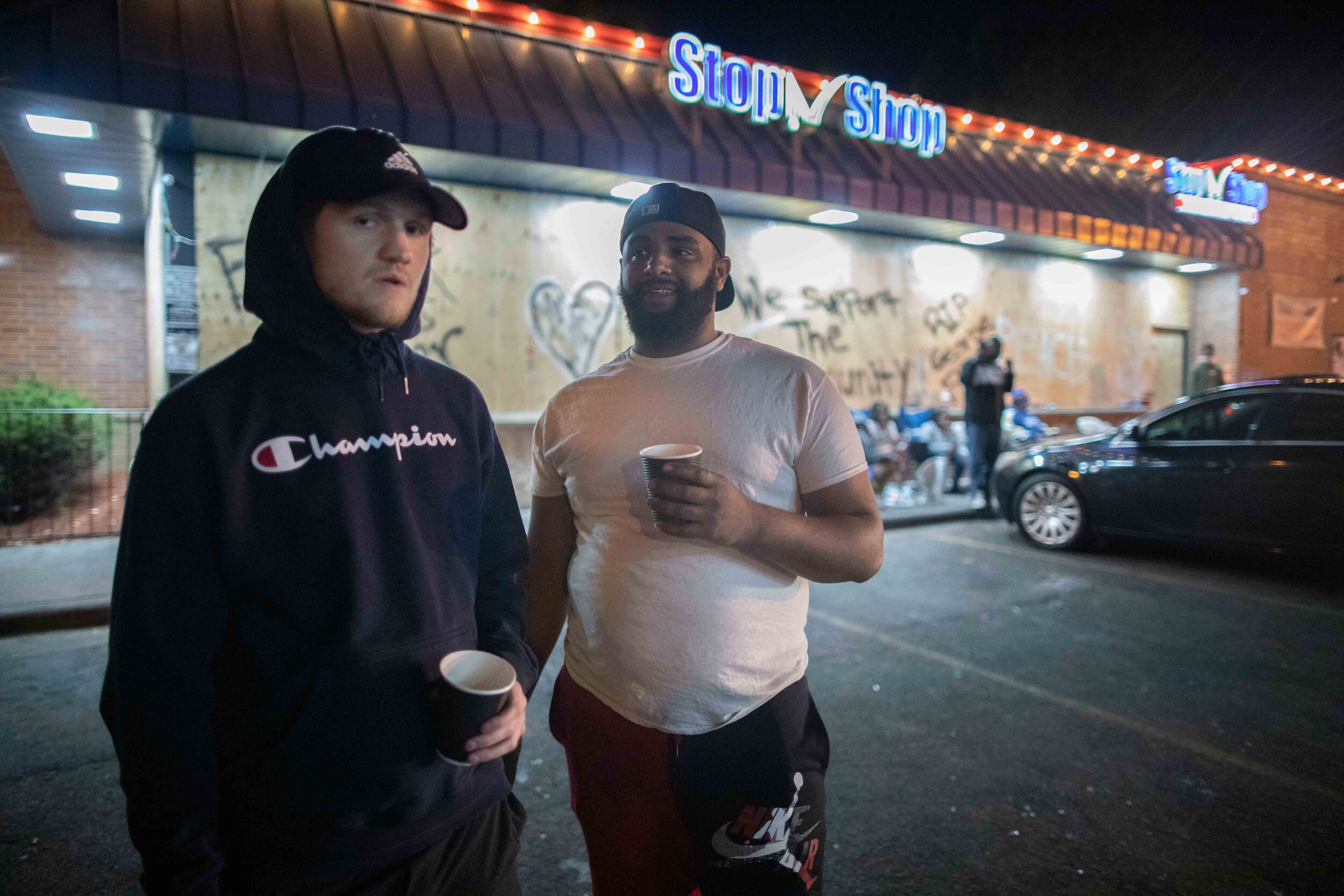  People stand guard over a gas station to prevent it from being further looted or burned down in riots that have swept through the Twin Cities over the police killing of George Floyd in Minneapolis, Minnesota on May 30, 2020. Chris Juhn/Zuma. 