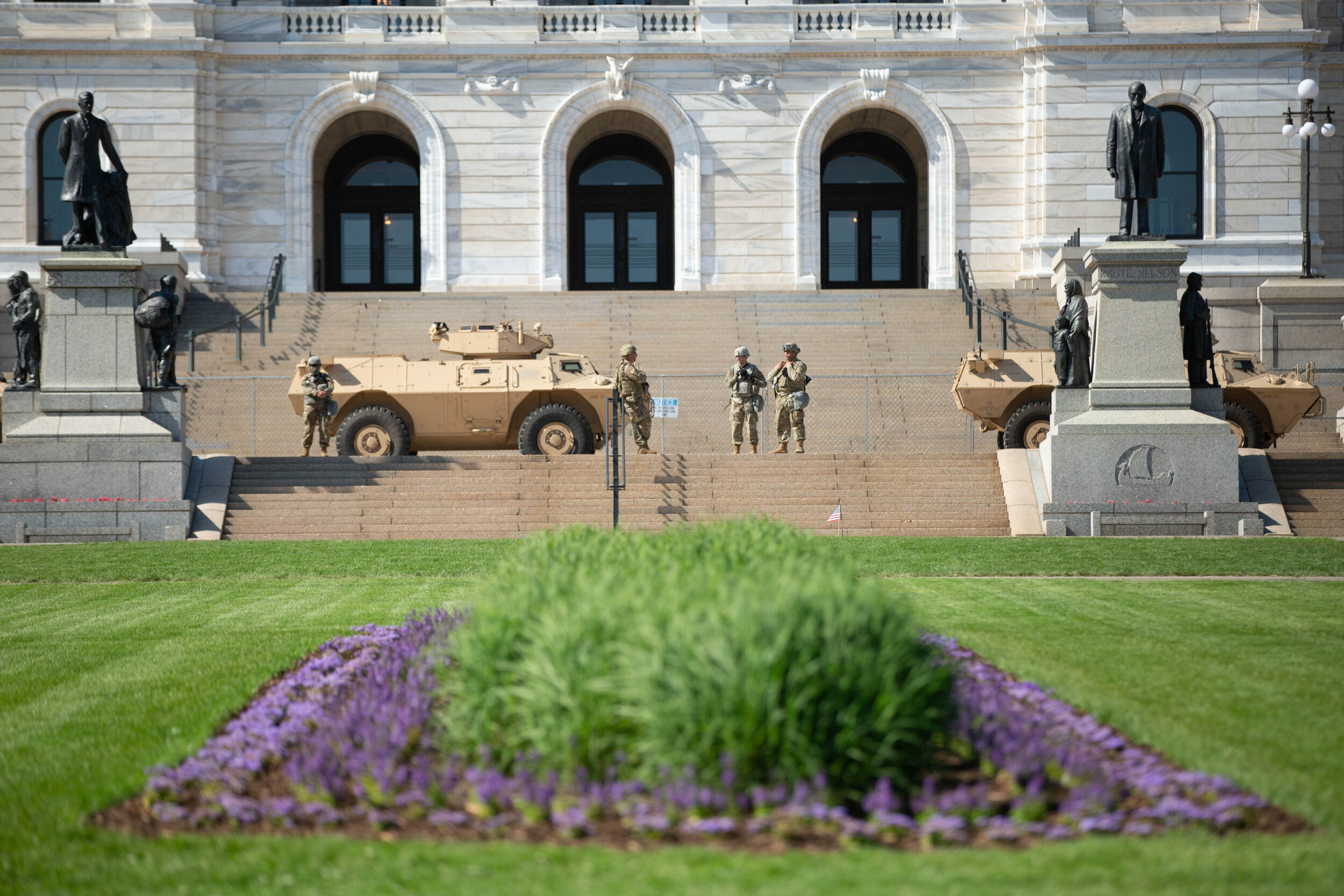  A blooming flower bed sits in front of Minnesota State Capitol as the National Guard set up armored vehicles and soldiers on the steps of the Captiol building in Saint Paul, Minnesota on June 1, 2020. Chris Juhn/Zenger 