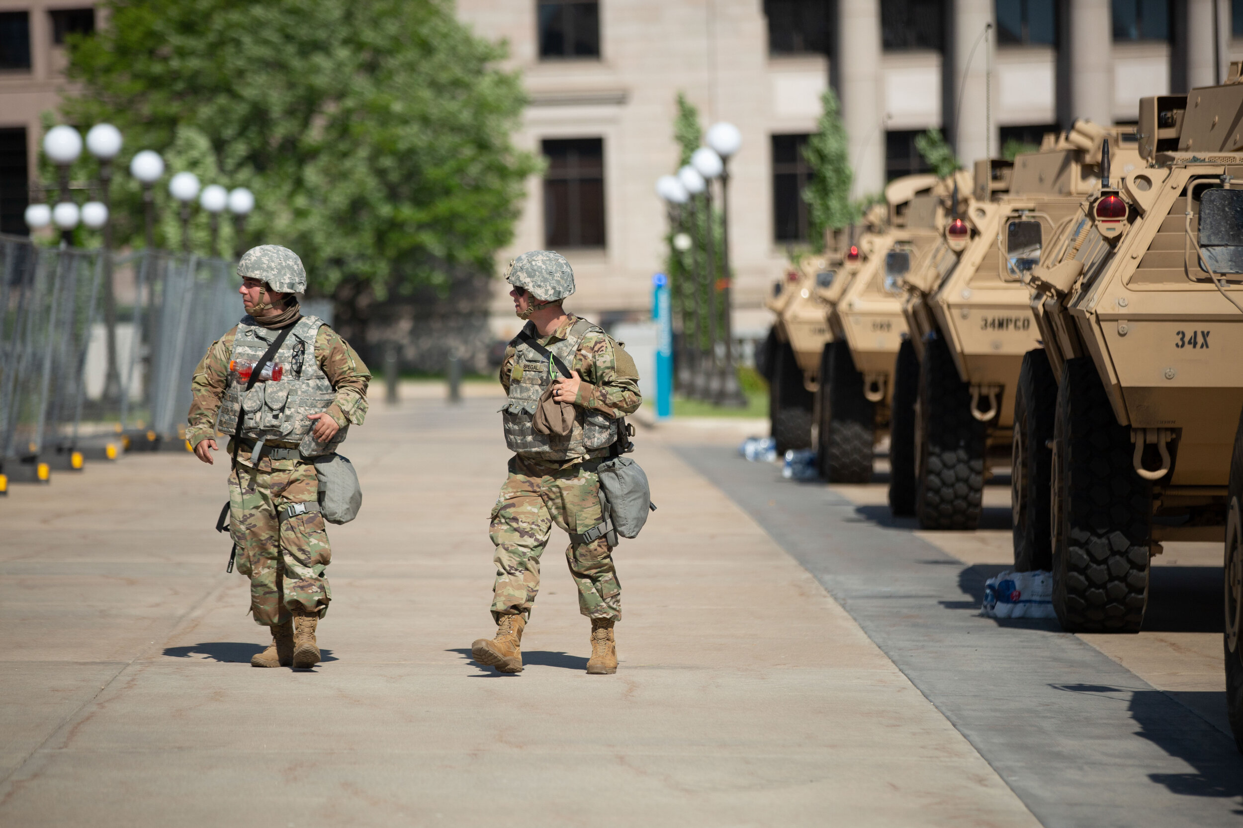  Two National Guard soldiers walk down a line of armored vehicles in front of the Minnesota State Capitol in Saint Paul, Minnesota on June 1, 2020. Chris Juhn/Zenger 