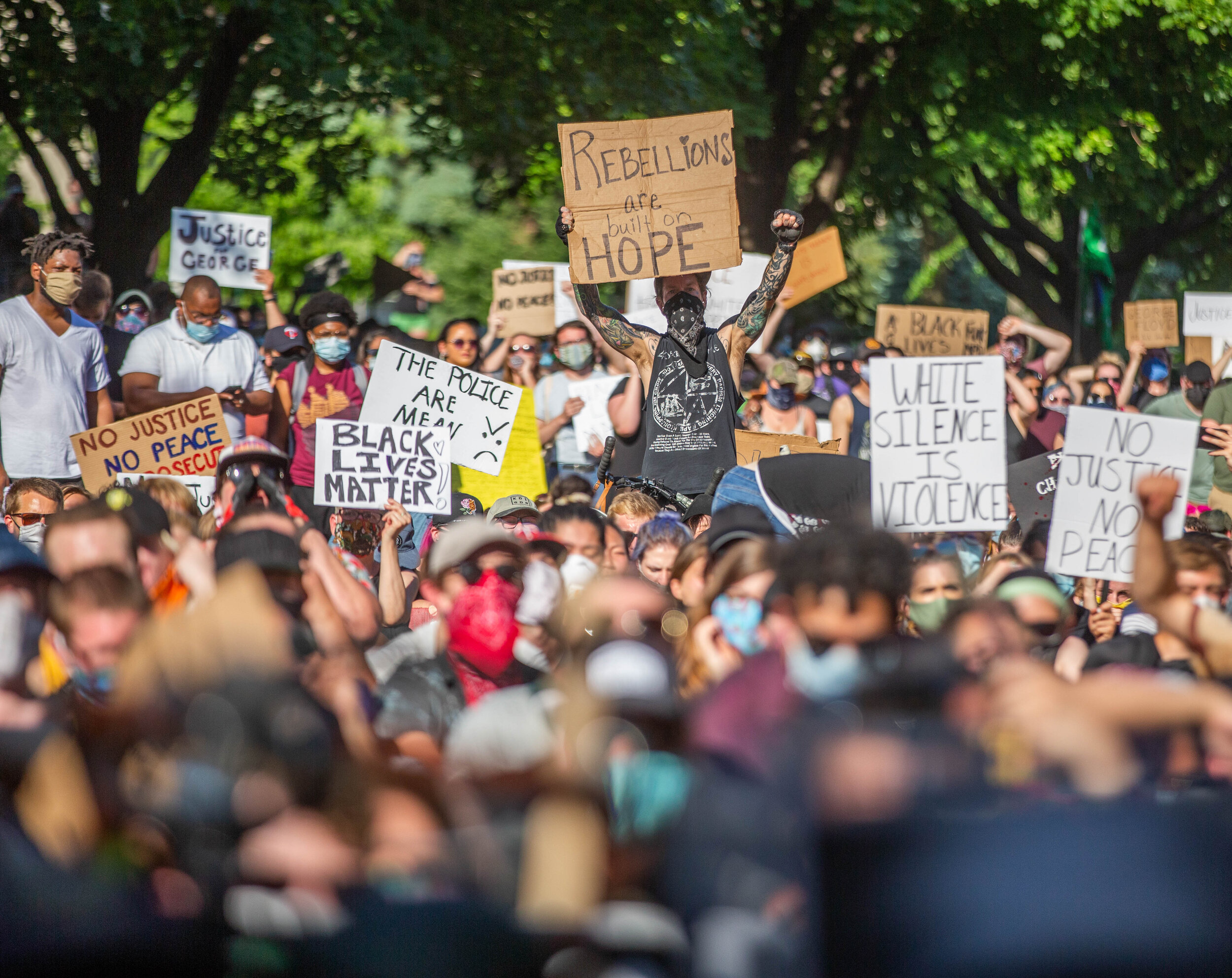  Protesters listen and hold signs up as speakers at a protest in front of the Governors Mansion speak in Saint Paul, MN over the police killing of George Floyd on June 1, 2020. Chris Juhn/Zenger 