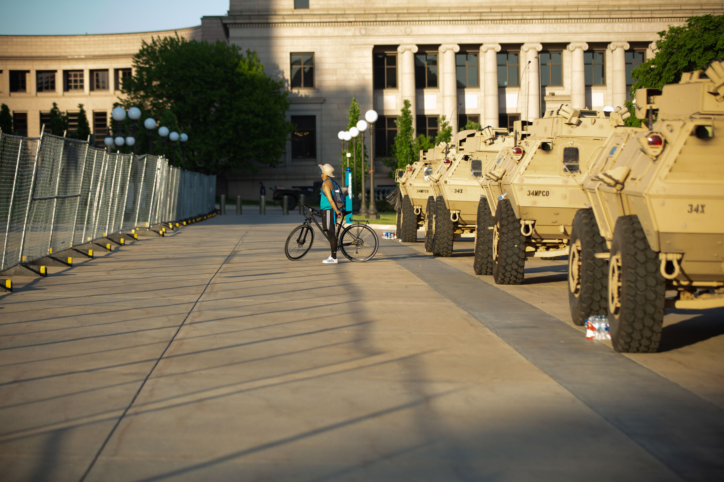  A biker stops in between the line of armored vehicles and the fence to guard the State Capitol building in Saint Paul, Minnesota during a peaceful protest on June 1, 2020. Chris Juhn/Zenger 