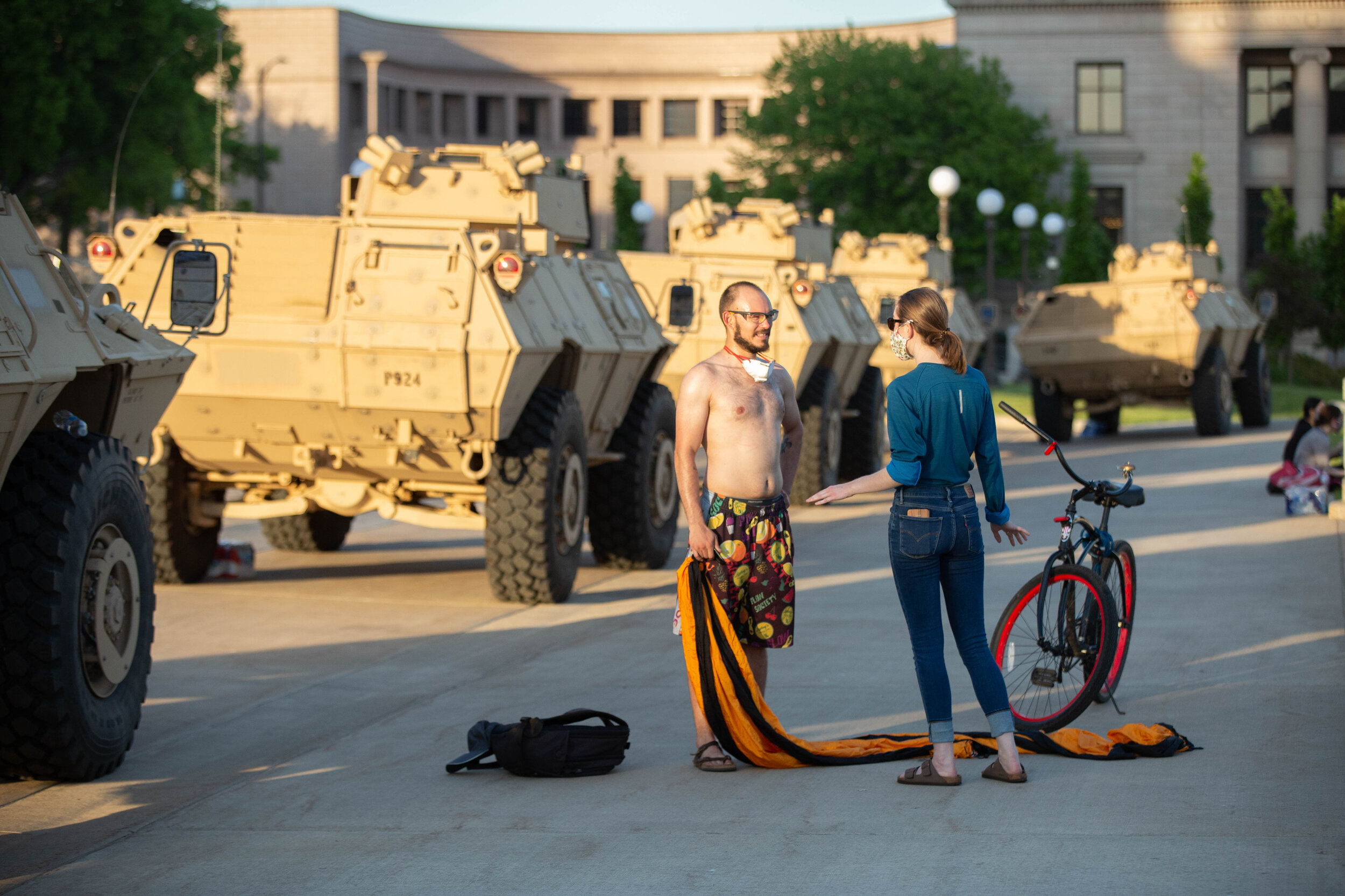  A man that was trying to hang a hammock between a fence and armored vehicle is told by protesters that he needed to stop at the Minnesota State Capitol building in Saint Paul, Minnesota on June 1, 2020. Chris Juhn/Zenger 