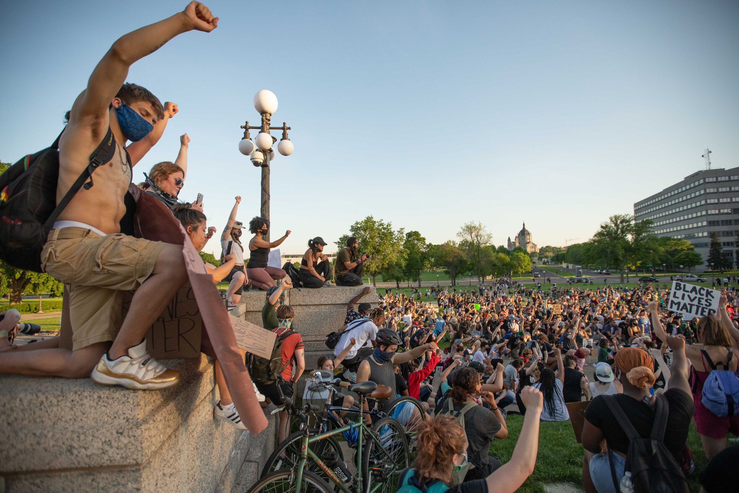  During a moment of silence for George Floyd proetsters bow their heads and raise their fists in the air while on the steps of the Minnesota State Capitol building in Saint Paul, Minnesota on June 1, 2020. Chris Juhn/Zenger 
