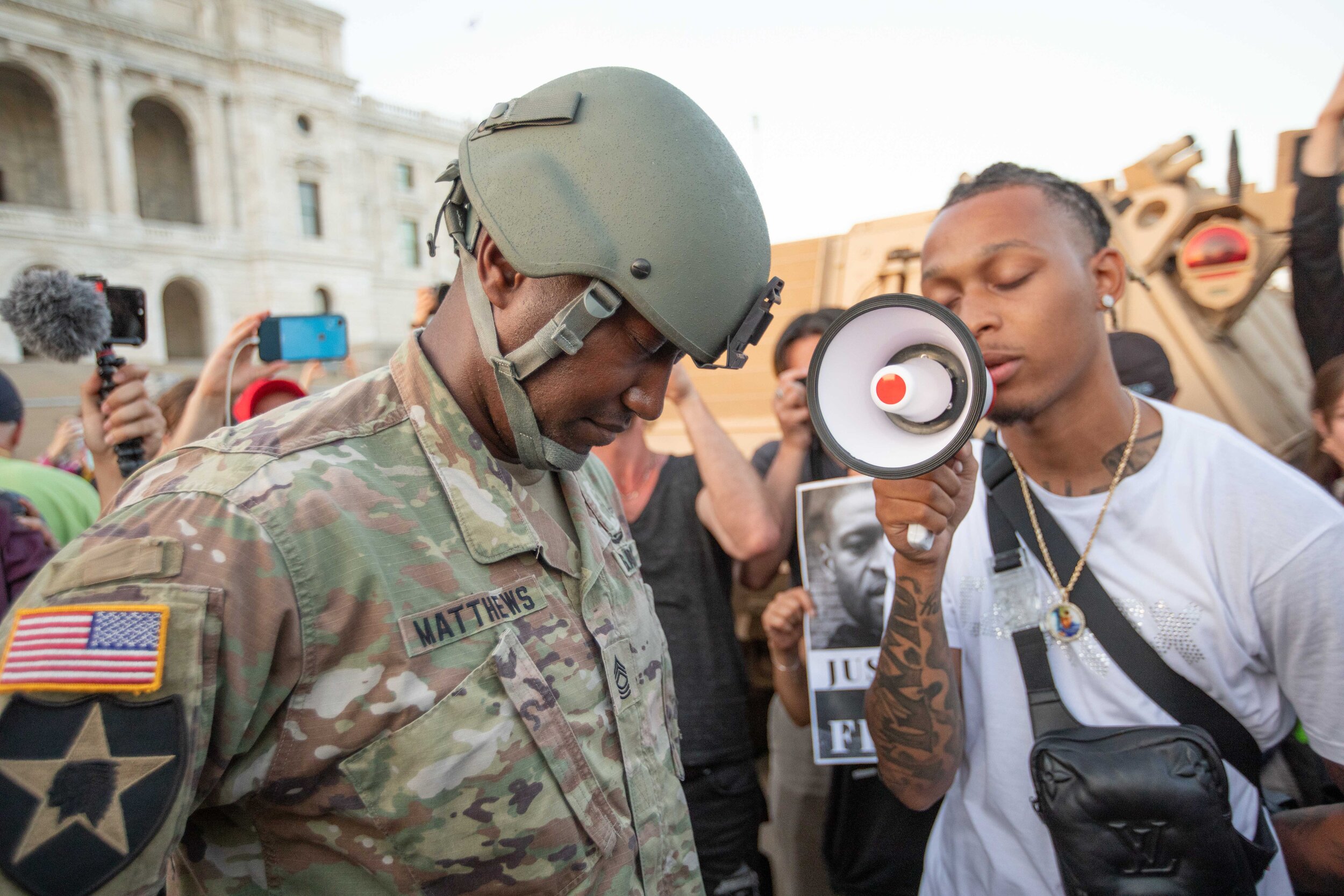  Master Sgt. Acie Matthews Jr., the Minnesota National Guard State Equal Opportunity Advisor bows his head as he prays with protesters on the steps of the Minnesota State Capitol in Saint Paul, Minnesota on June 1, 2020. Chris Juhn/Zenger 