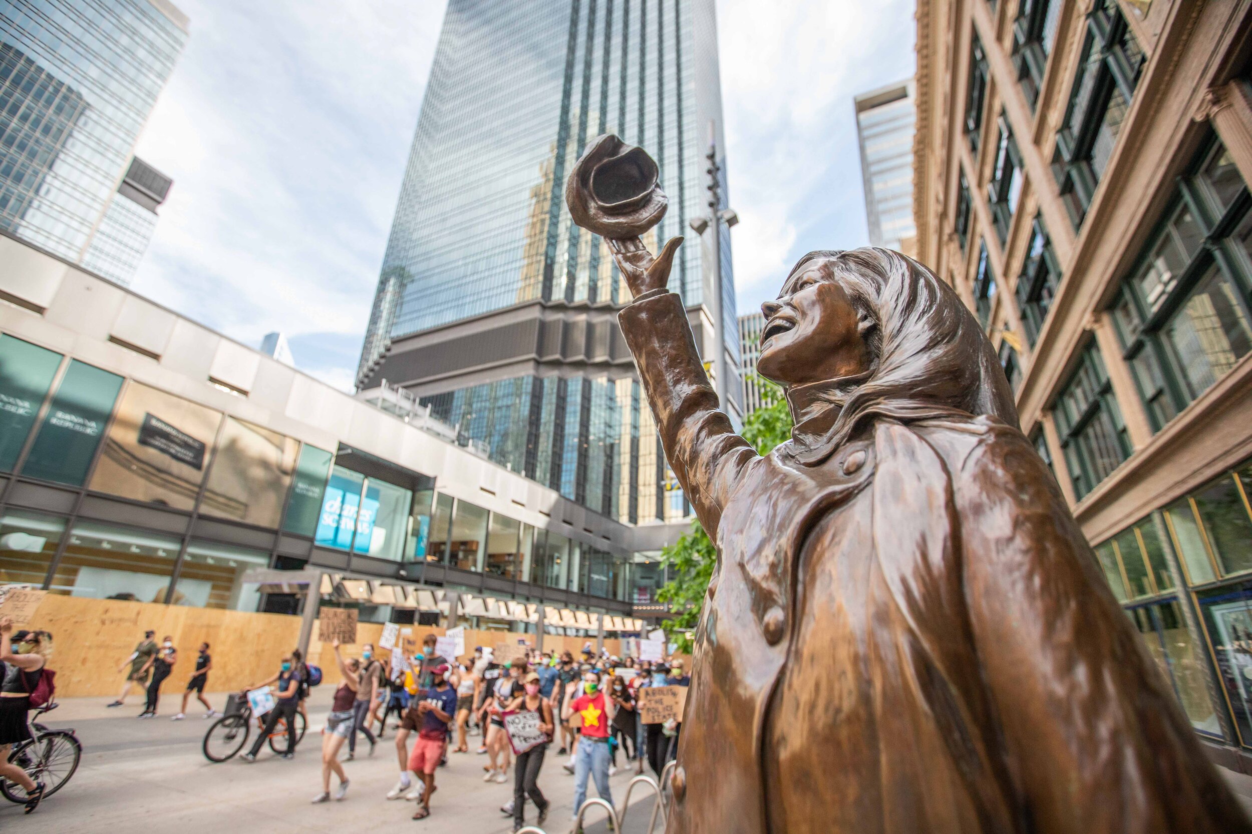  Protesters march past the Mary Tyler Moore staue on Nicollet Ave in Minneapolis, Minnesota as they protest to demand that Liz Collin be fired from WCCO as a news anchor. Liz is married to Bob Kroll, the President of the Minneapolis Police Union on J