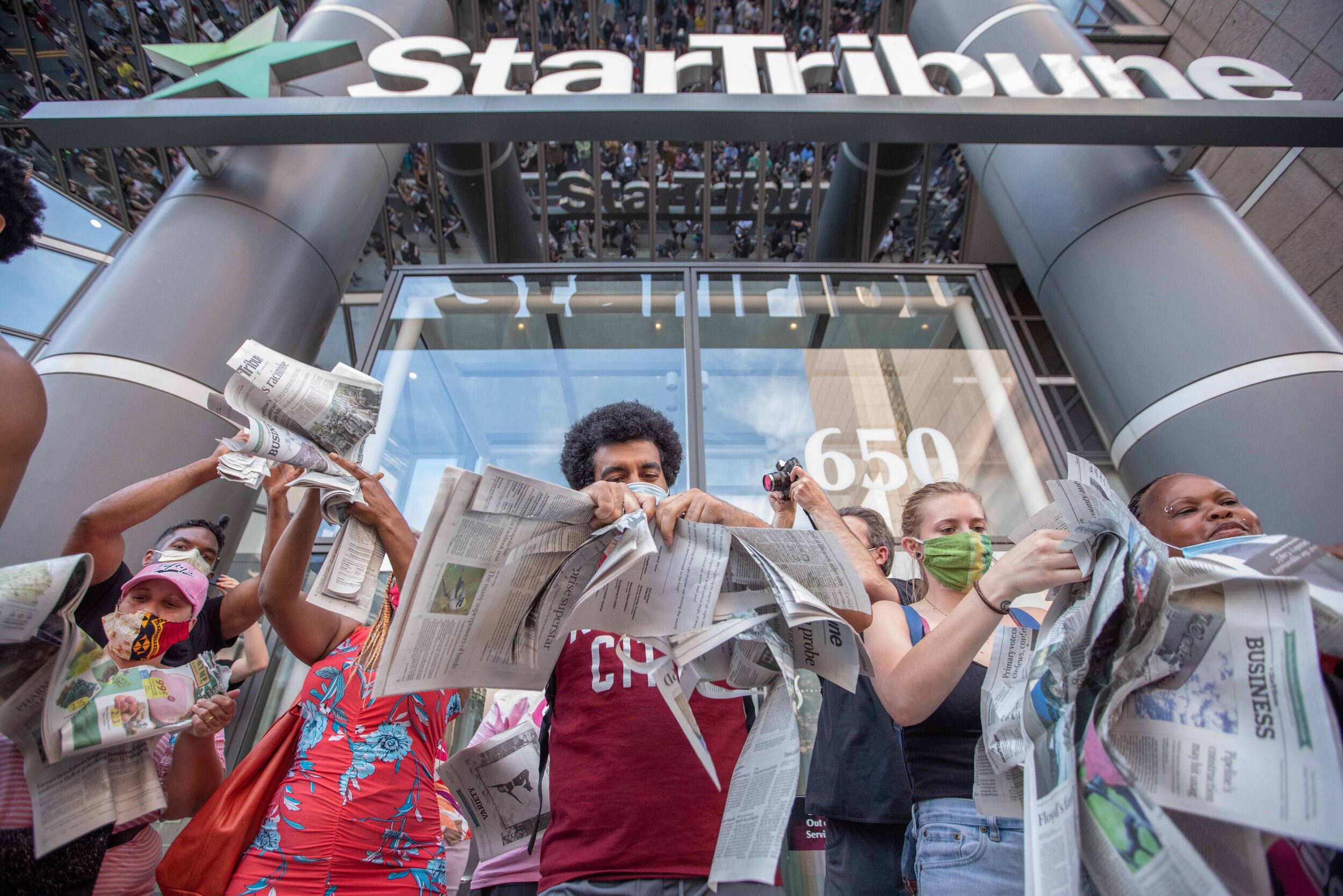  Protesters tear up copies of Star Tribune newspapers in front of the Star Tribune building in Minneapolis, Minnesota as they protest the way the paper has covered issues in the past on Jun 3, 2020. 