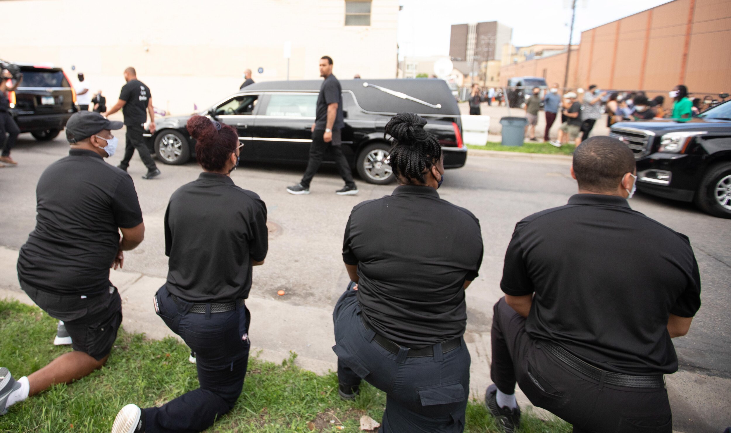  Firefighters take a knee in honor of George Floyd as the hearse containing his casket drives by at a memorial for George at North Central University on Jun 4, 2020. 