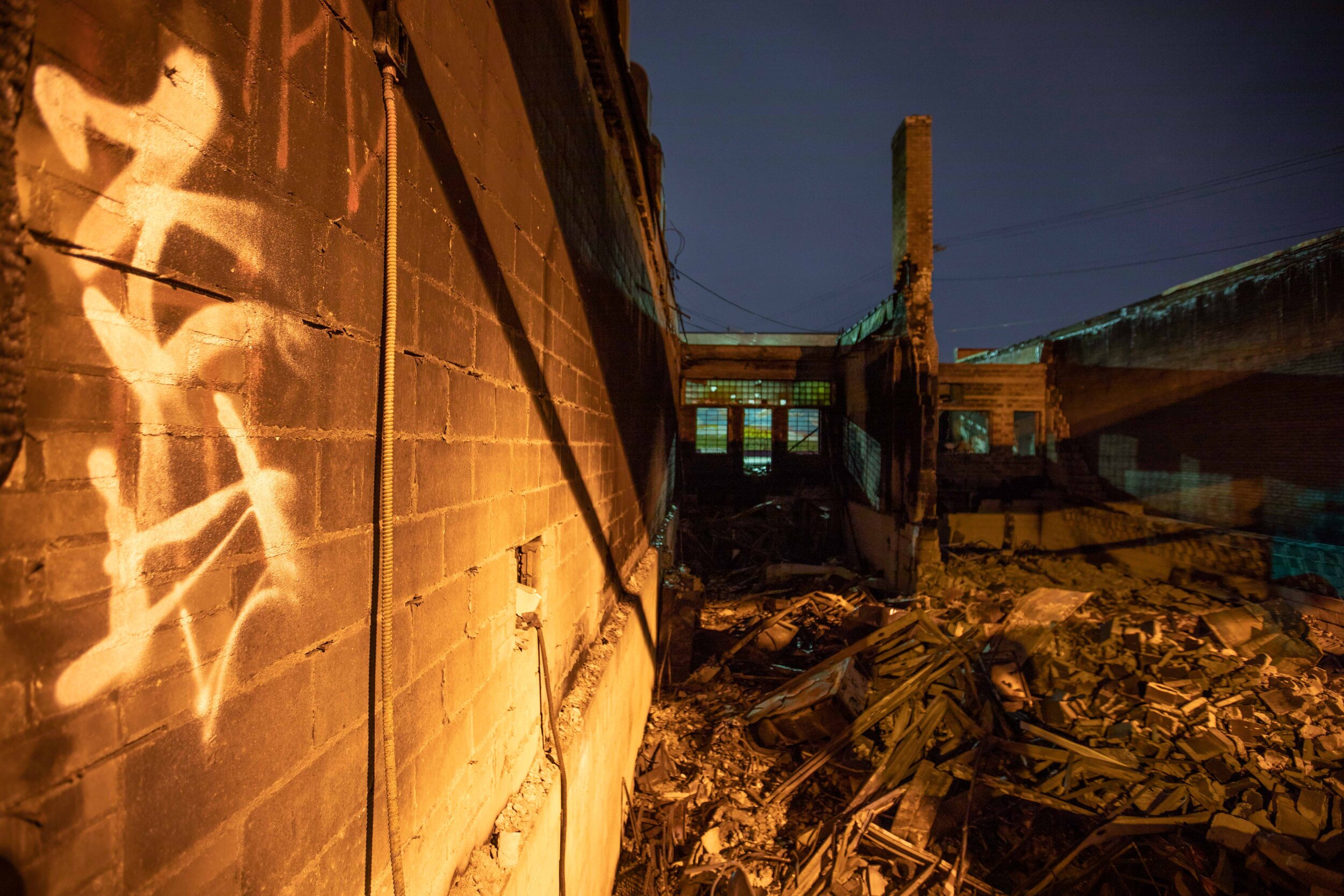  A destroyed building sits lit by street lights. After riots broke out over the police killing of George Floyd this building was set on fire in Minneapolis, Minnesota on Jun 8, 2020. 
