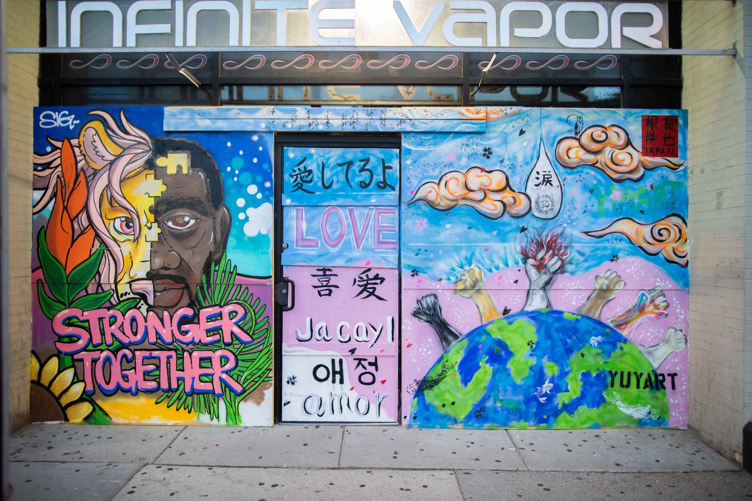  The artist Yuya Negishi painted this mural on the Infinite Vapor store. In the wake of George Floyd's death at the hands of the Minneapolis police riots and looting broke out all over the Twin Cities. Many businesses put boards up over windows in an