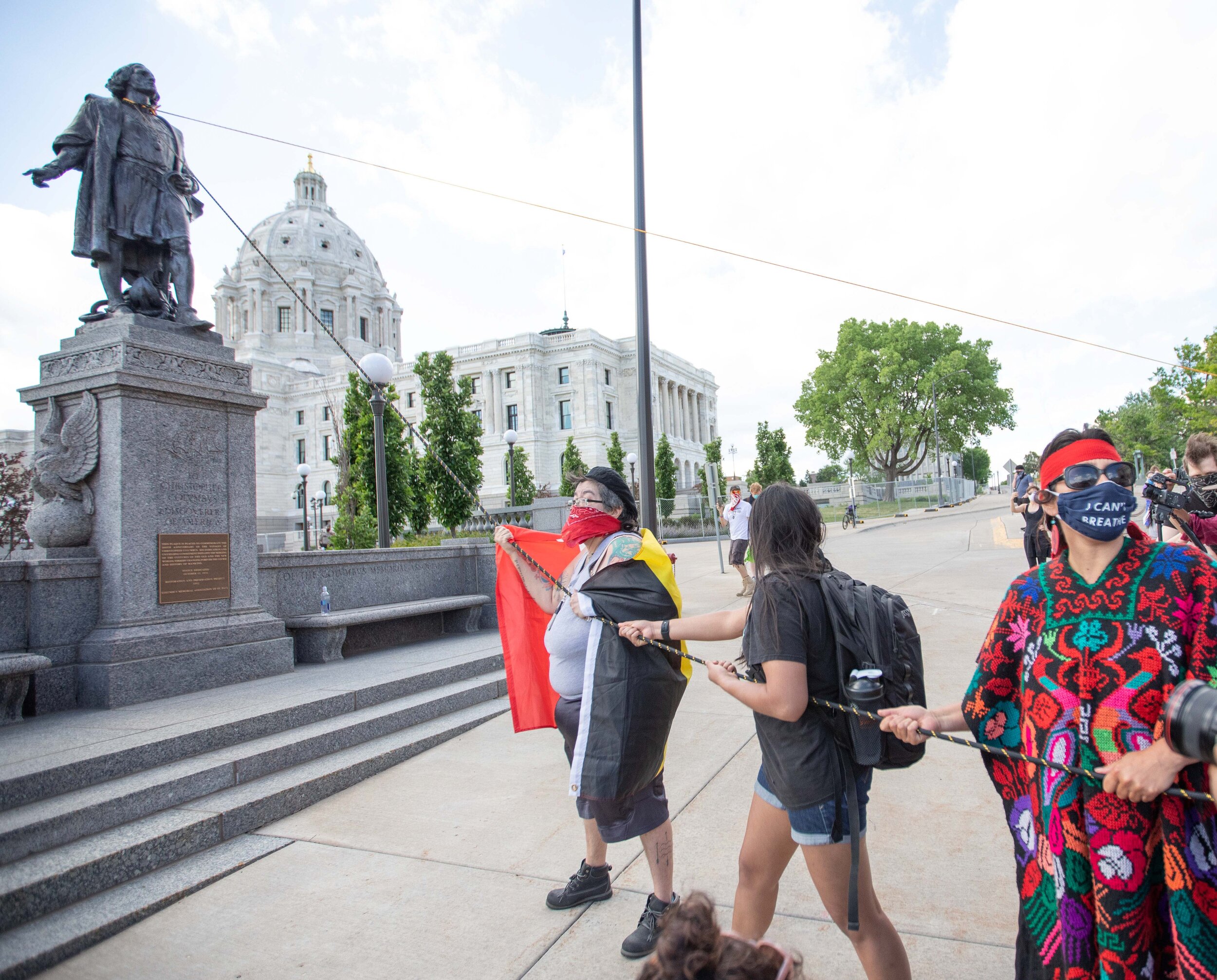  Native American women form 2 lines to rip down the Christopher Columbus statue on the grounds of the State Capitol in Saint Paul, Minnesota on Jan 10, 2020. 