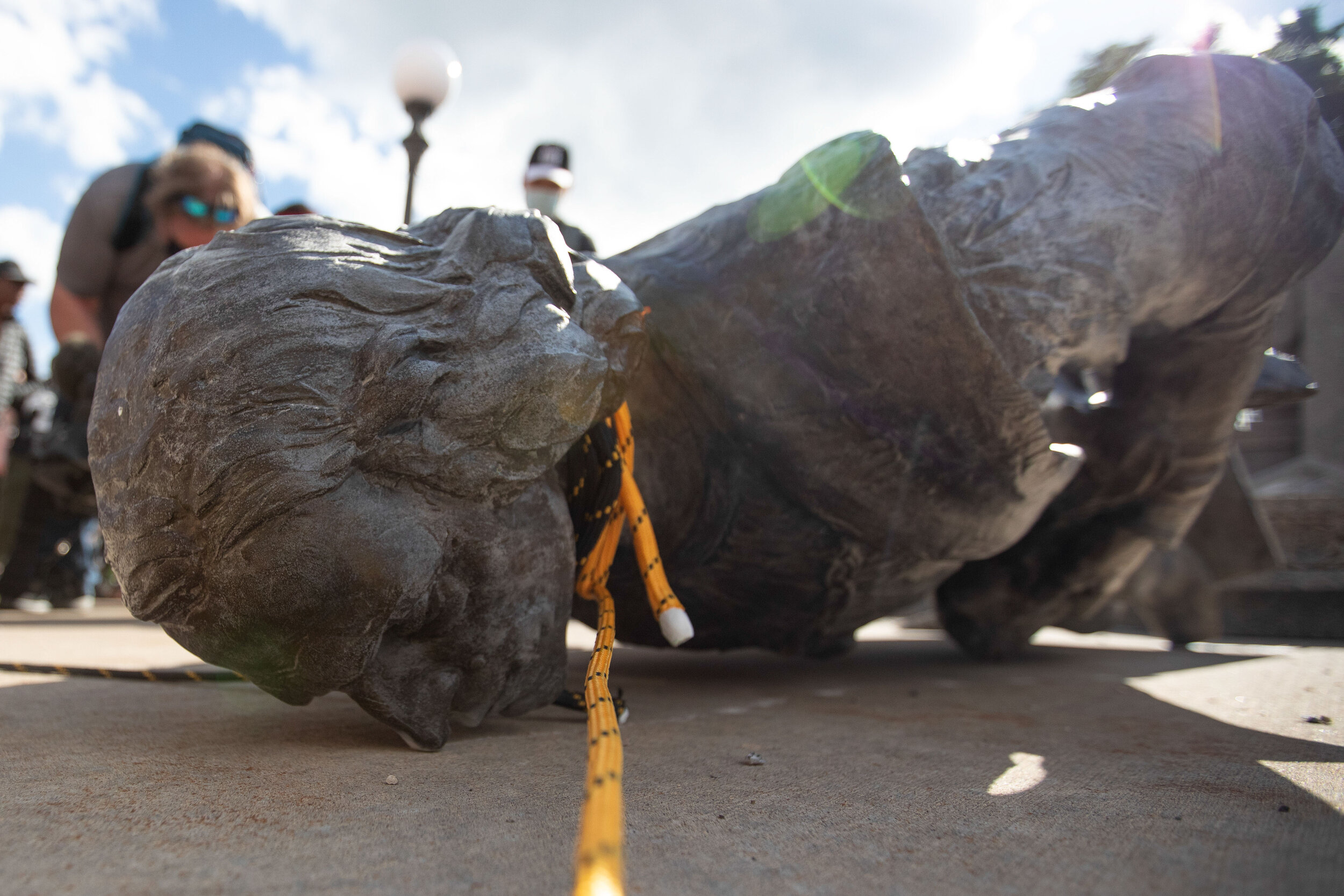  With the rops till wrapped around its neck, the statue of Christopher Columbus at the State Capitol in Saint Paul, Minnesota lays face down on Jun 10, 2020. 