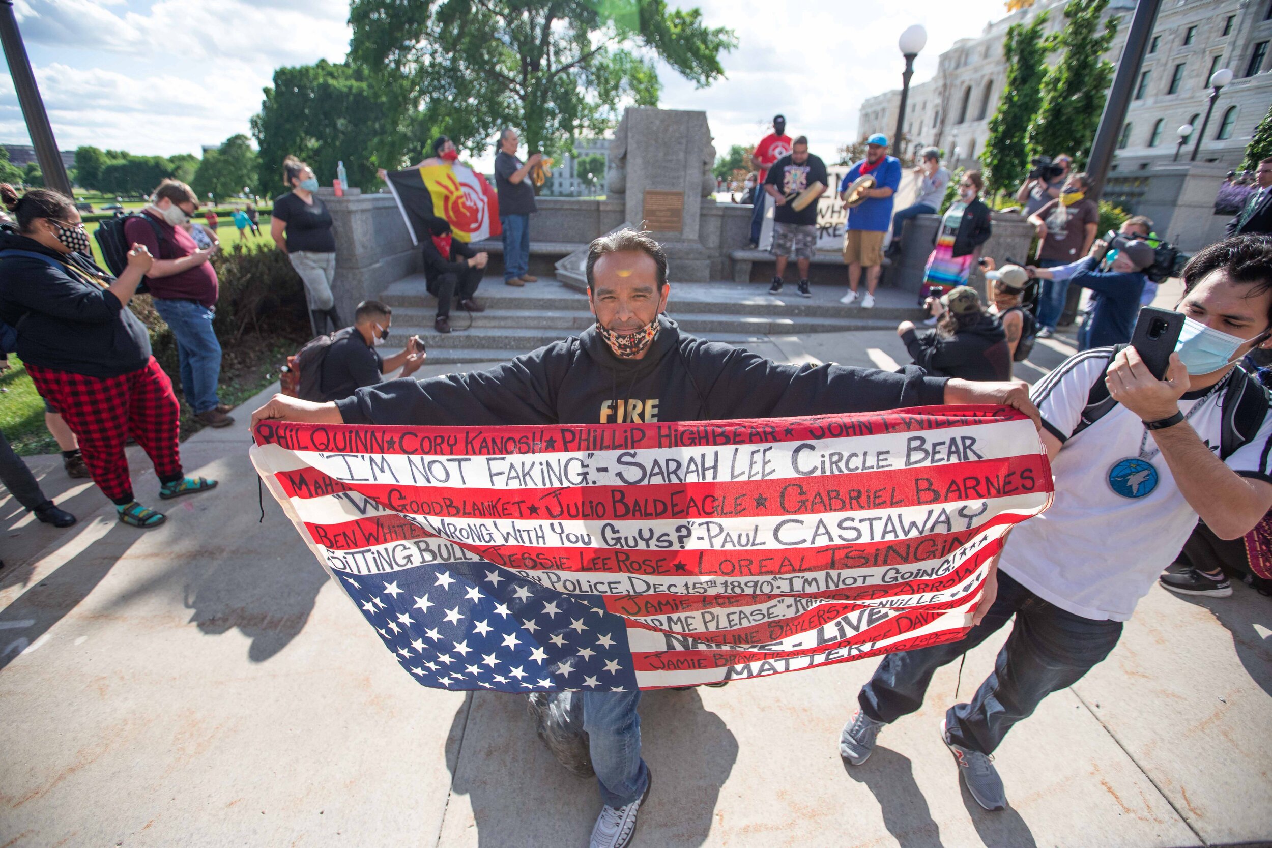  An activist poses over the recently torn down Christopher Columbus statue on the grounds of the State Capitol in Saint Paul, Minnesota on Jun 10, 2020. 