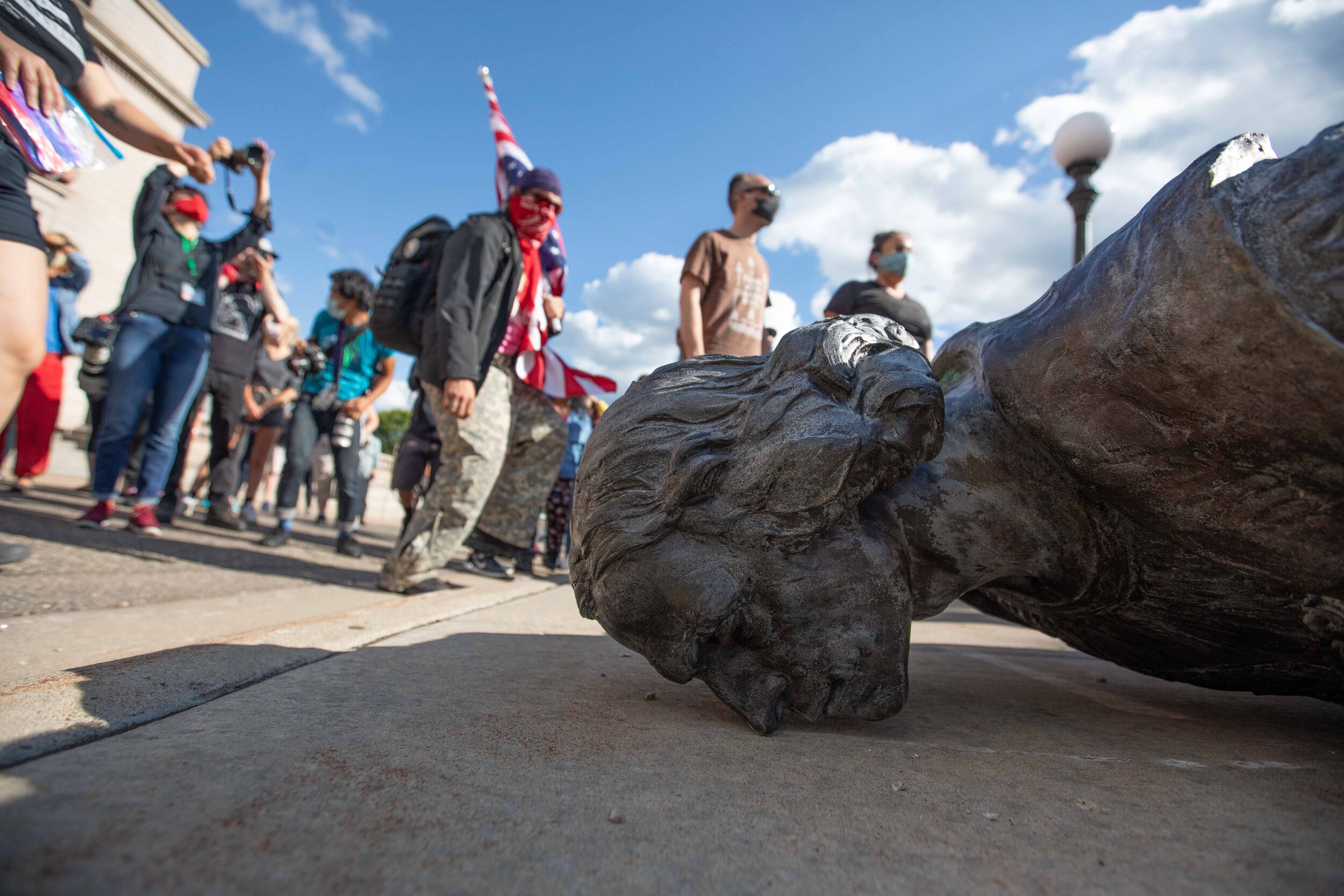  Activists hold hands and dance around the torn down Christopher Columbus statue in Saint Paul, Minnesota on Jun 10, 2020. 