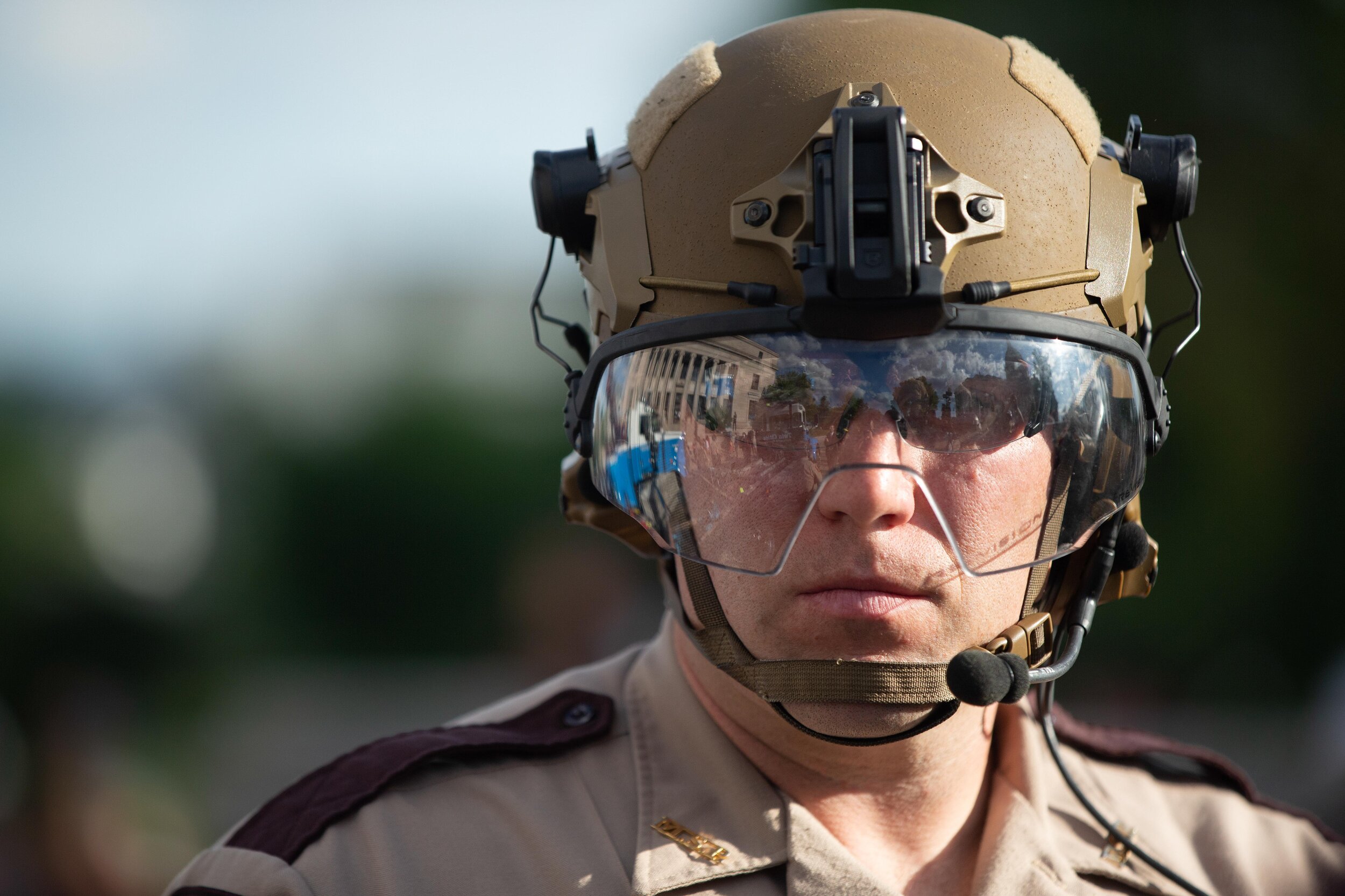  The visor on the helmet reflect on a State Trooper as he stands guard over the Christopher Columbus statue torn down by activists in Saint Paul, Minnesota on Jun 10, 2020. 