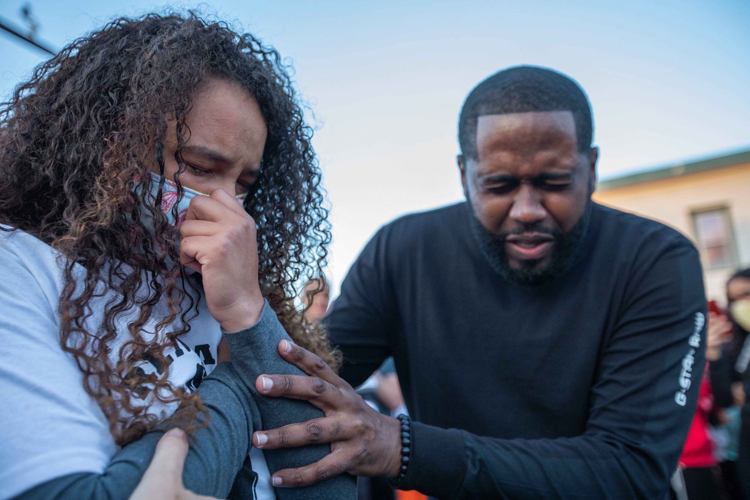  Sade Strong (left) prepares to be baptised on the street of George Floyd Square as Pastor Joshua Giles prays over her before baptizing her in Minneapolis, Minnesota on Jun 13, 2020. 