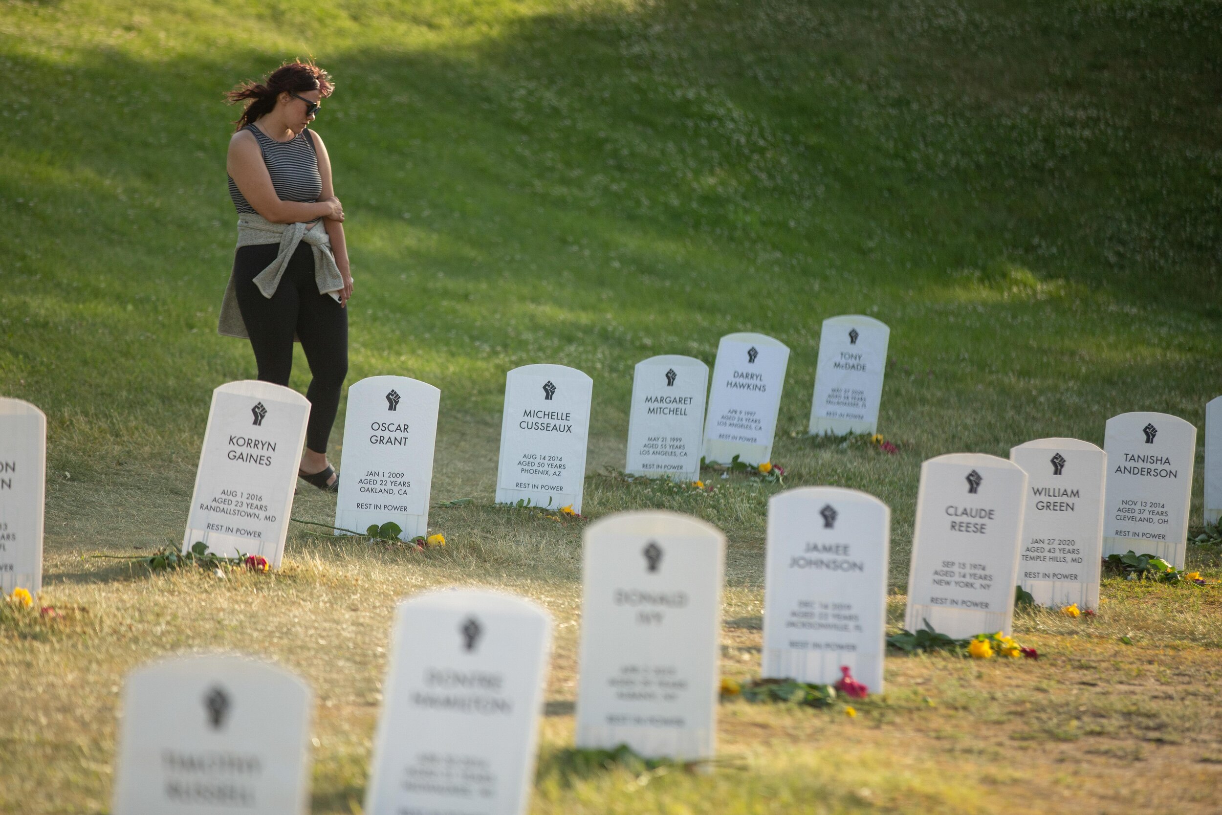  Walking around amock grave site of victims from around the country of police violence, a women stops and stares at a name in Minneapolis, Minnesota on Jun 14. 