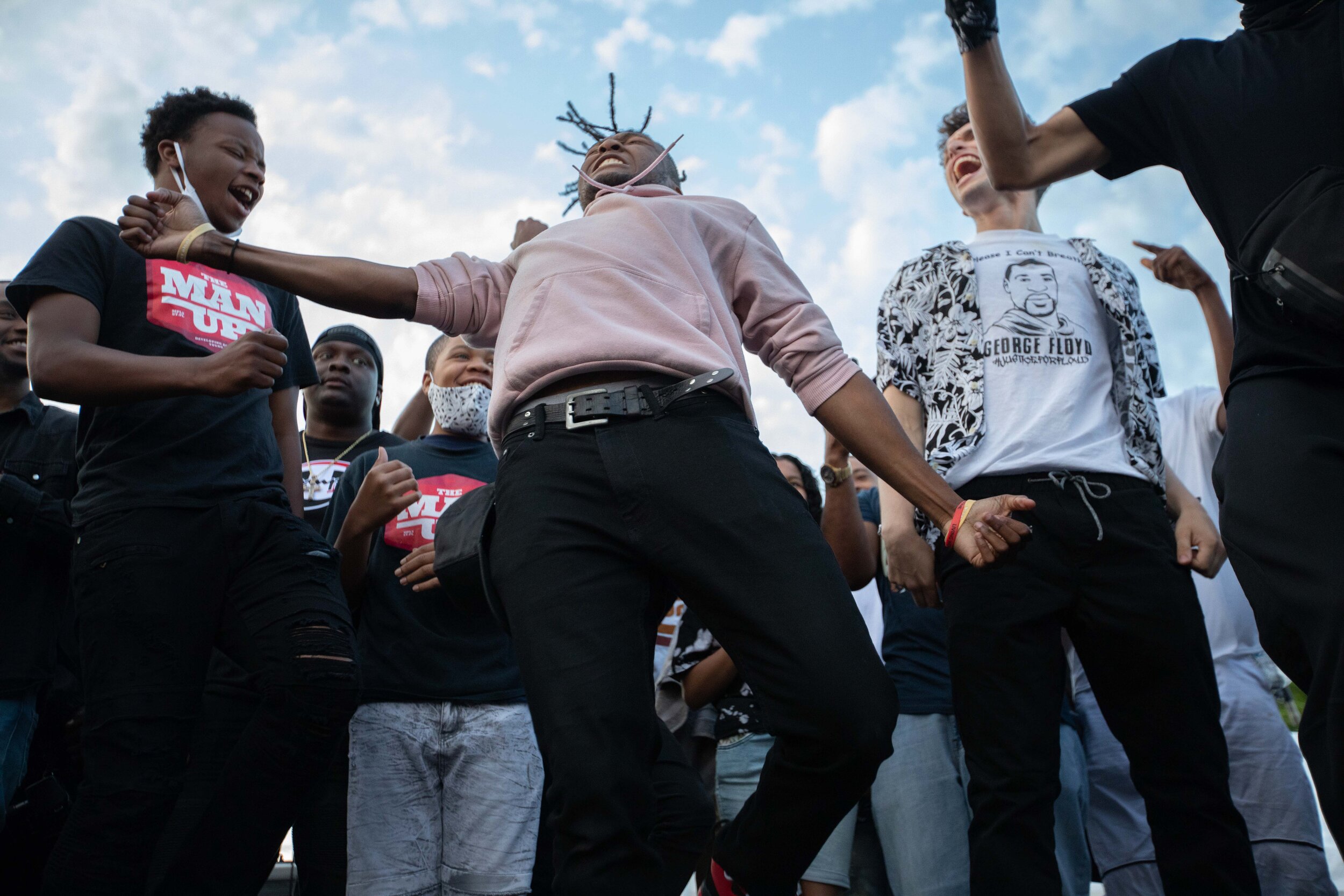  At the George Floyd memorial, a young man dances while the hip Christian hop artist Xross performs the song OMG. Xross founded the Man Up Club and lead a prayer at the memorial site in Minneapolis, Minnesota on Jun 14, 2020. 