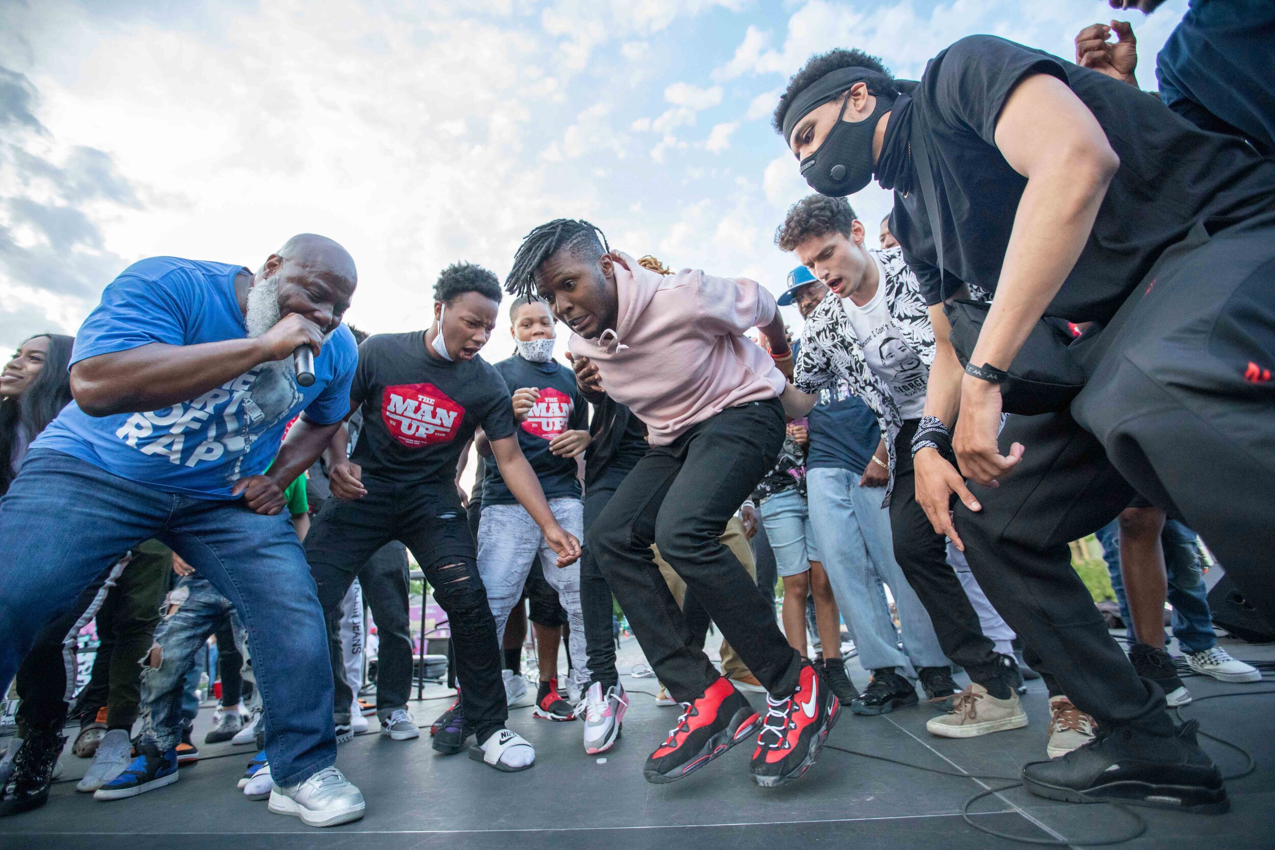  At the George Floyd memorial, young men dance while the hip Christian hop artist Xross performs the song OMG. Xross founded the Man Up Club and lead a prayer at the memorial site in Minneapolis, Minnesota on Jun 14, 2020. 
