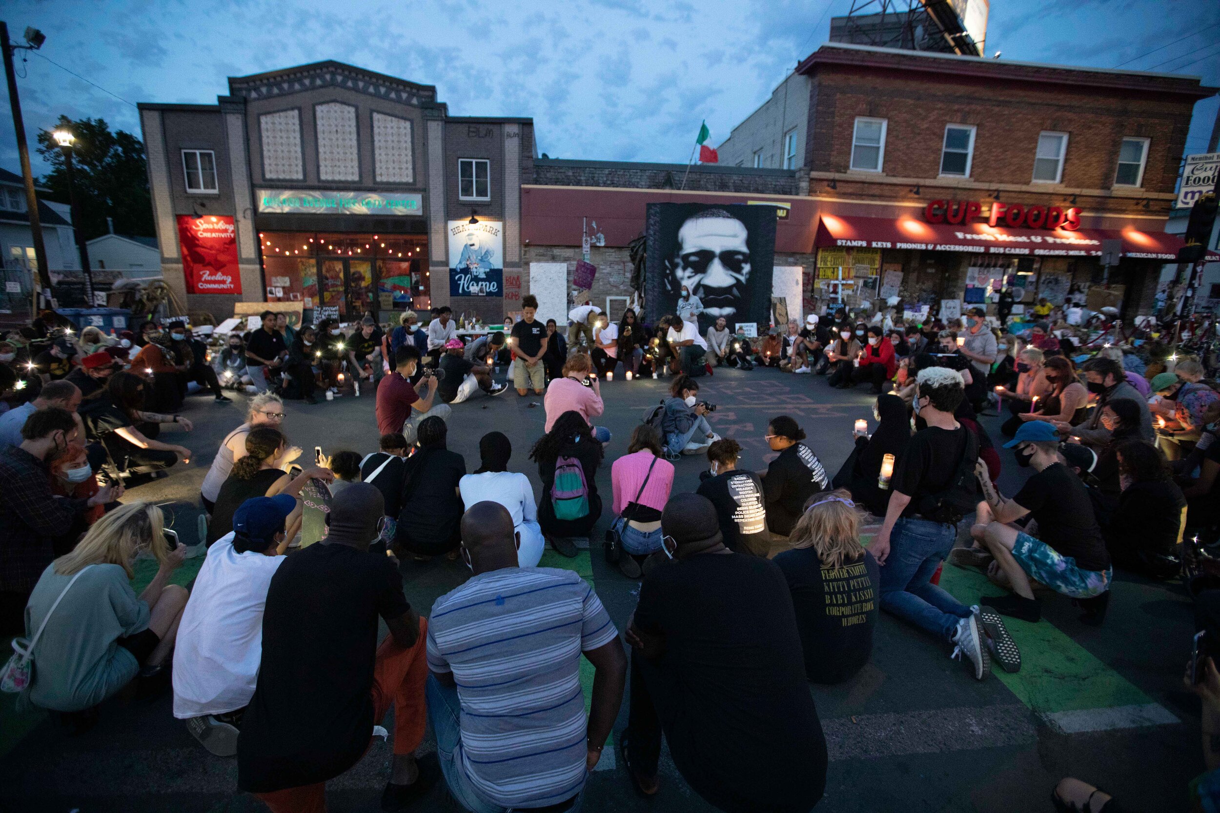  Community members take a knee for 8 minutes and 46 seconds in front of the George Floyd memorial in Minneapolis, Minnesota on Jun 14, 2020. 