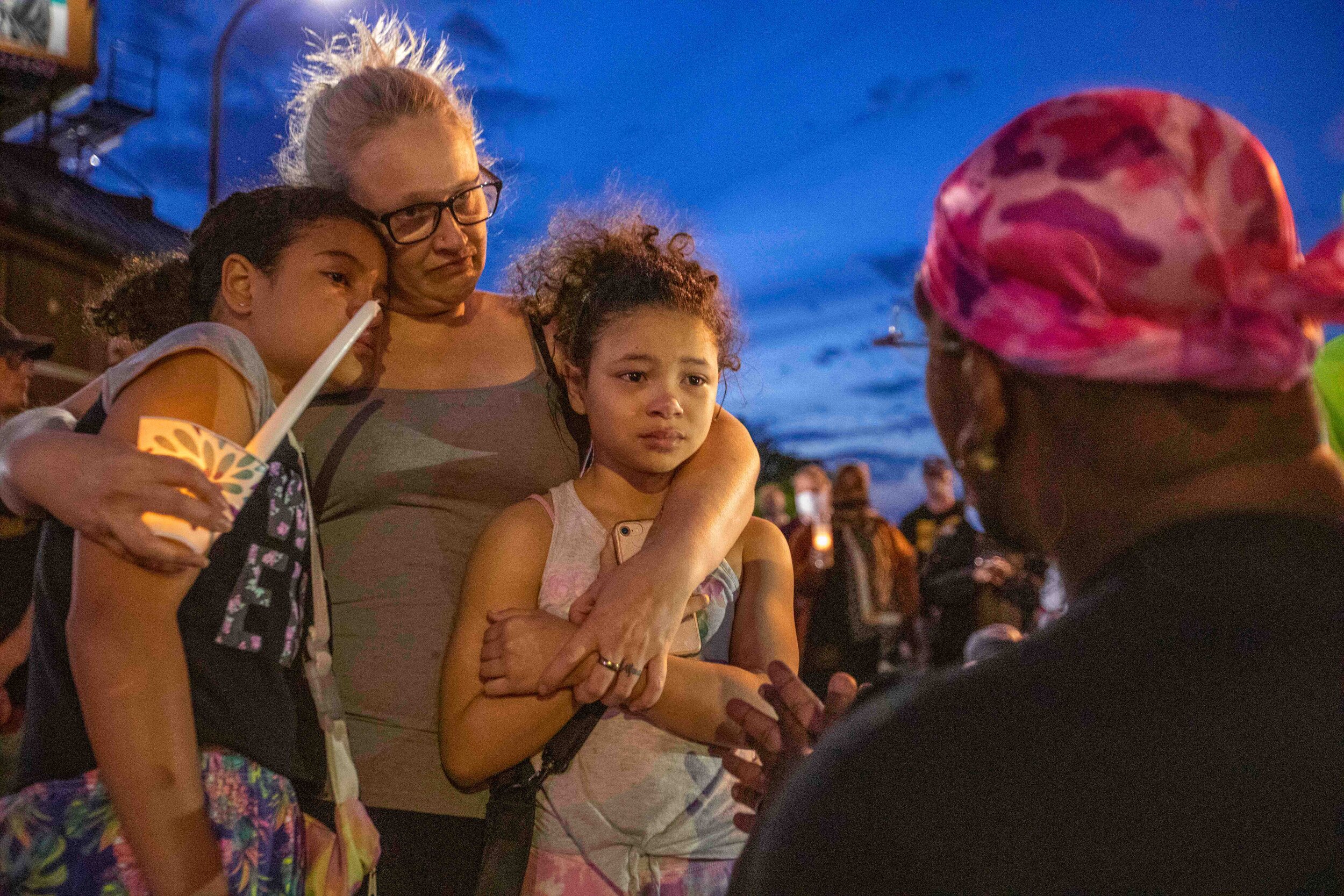  A man talks to 2 girls and tells them they're perfect and why they are out here fighting for justice at the site of the memorial for George Floyd in Minneapolis, Minnesota on Jun 14, 2020. 