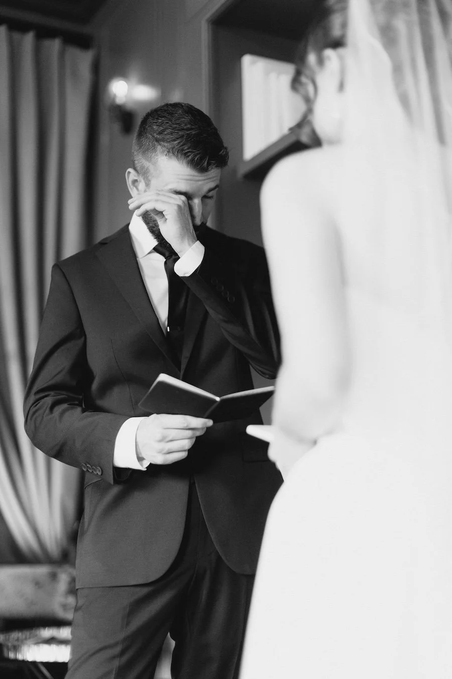 Bride and groom emotional moment reading private vows to each other at Delamar West Hartford, CT
