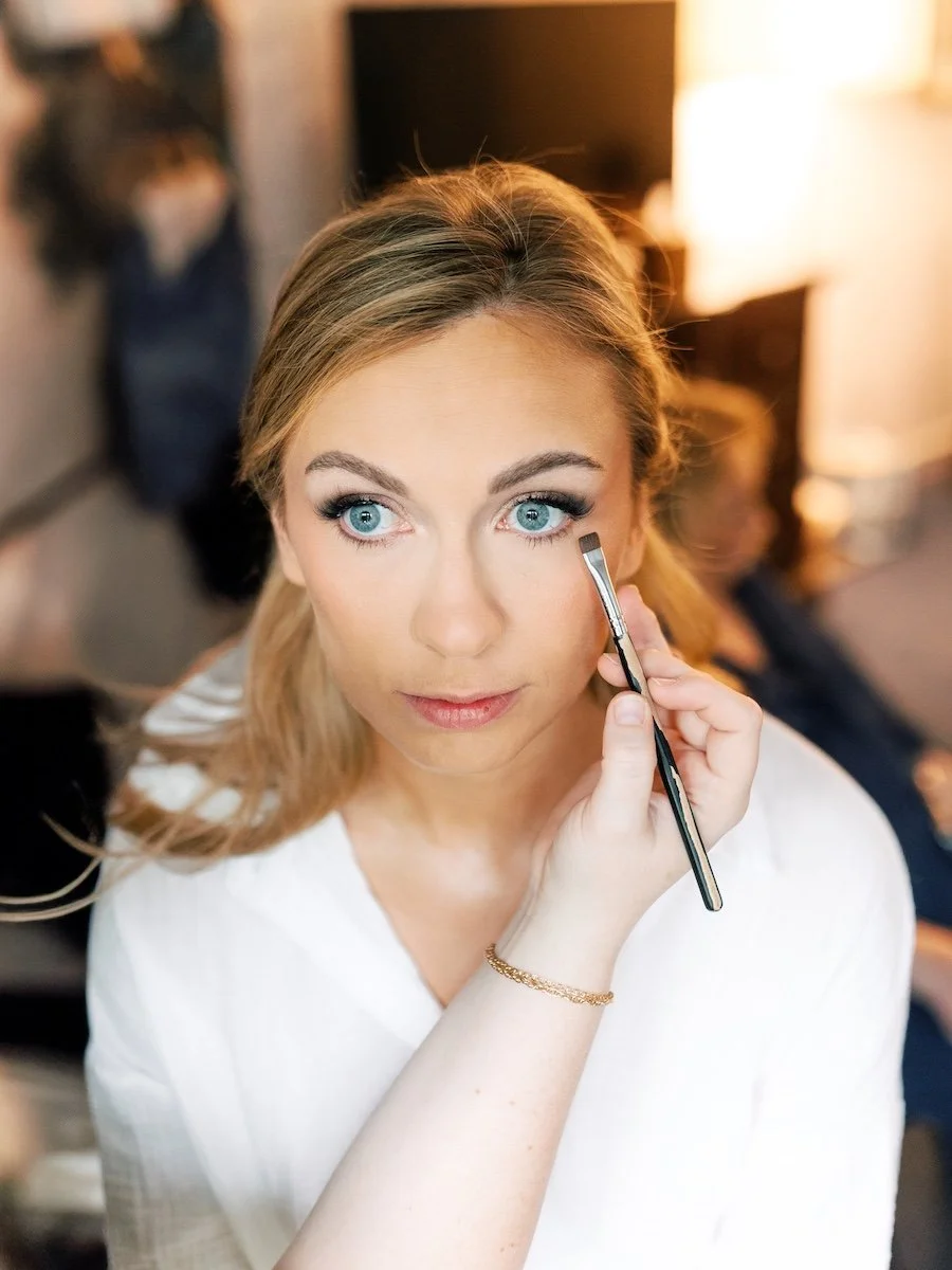 Classic getting ready photo of the bride doing make up for the wedding in Farmington Polo Club, Connecticut