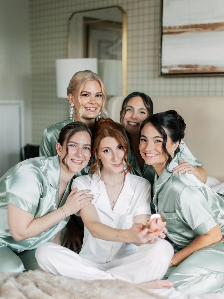 Bride Ali with bridesmaids fun photo on the bed