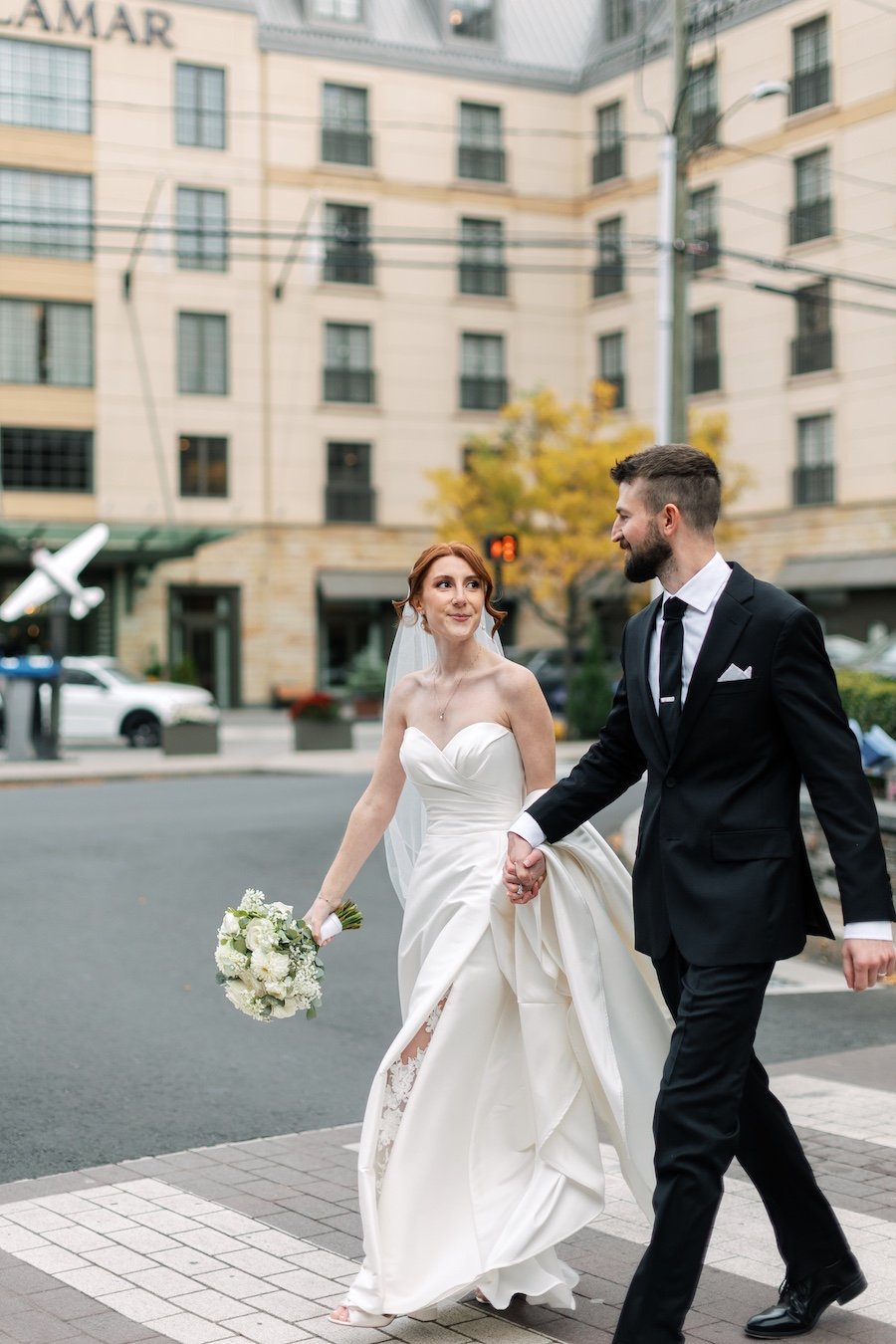 Classic bride and groom walking photos outside of Delamar West Hartford