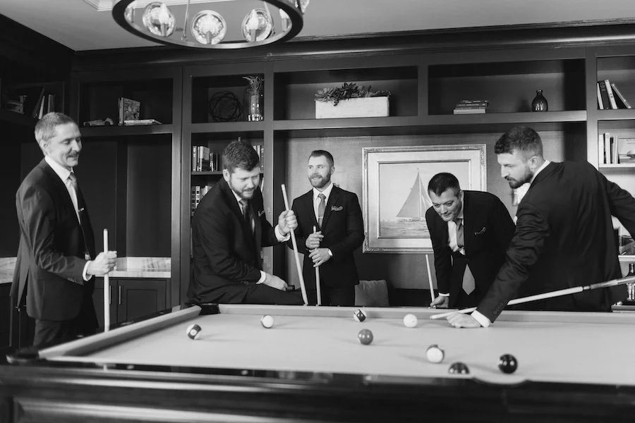 Jeff and groomsmen playing pool at Delamar West Hartford before the wedding ceremony
