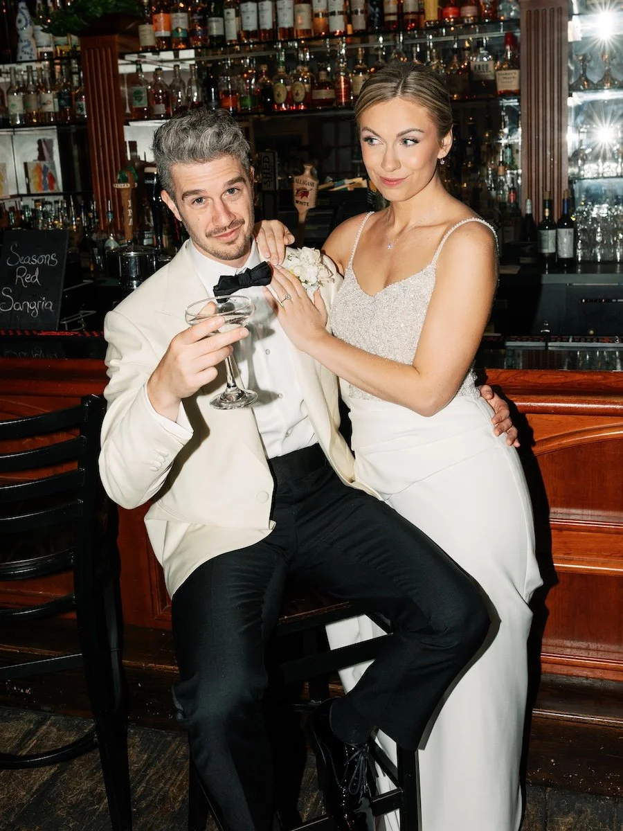 Classic vintage flash style portrait of bride and groom at the bar at Farmington Polo Club, Connecticut