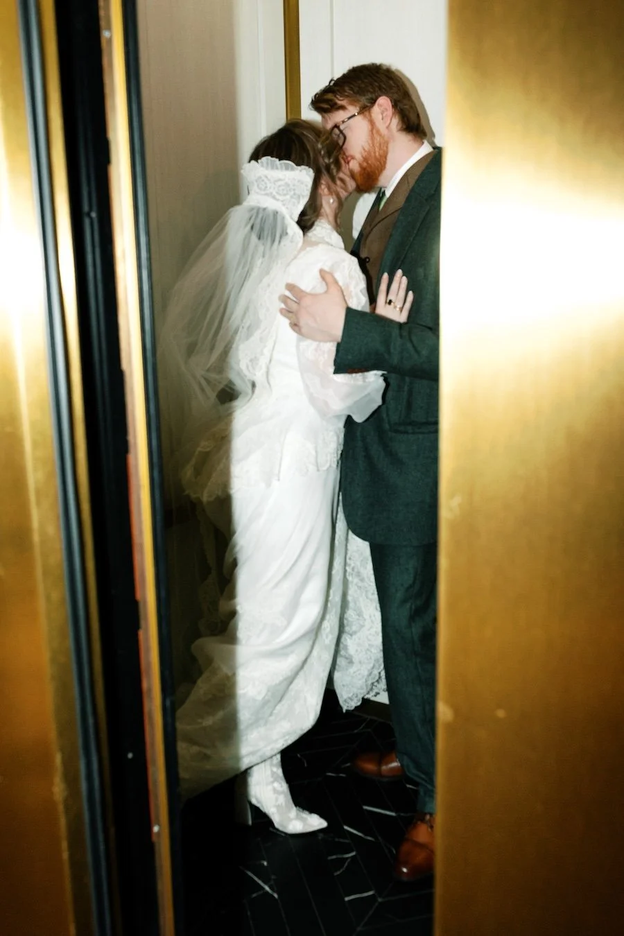 Classic bride and groom kiss in the elevator at Pond House Cafe wedding, Connecticut