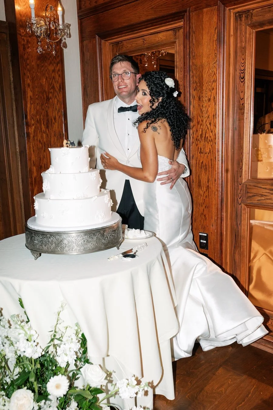 Bride and groom cut the wedding cake at Saint Clements