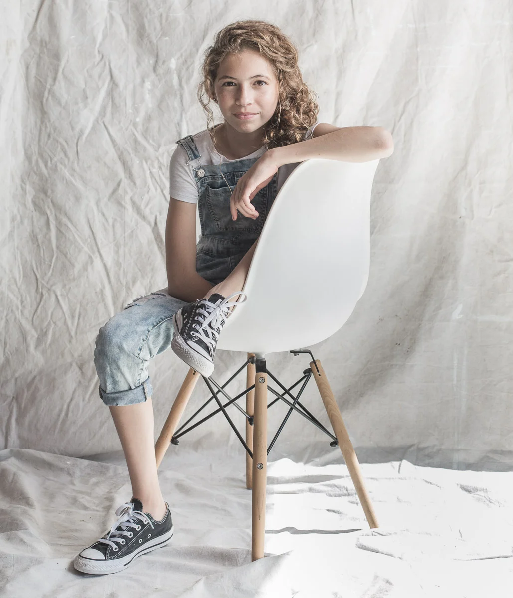 Teen girl in chair by Ryan Pavlovich Photography