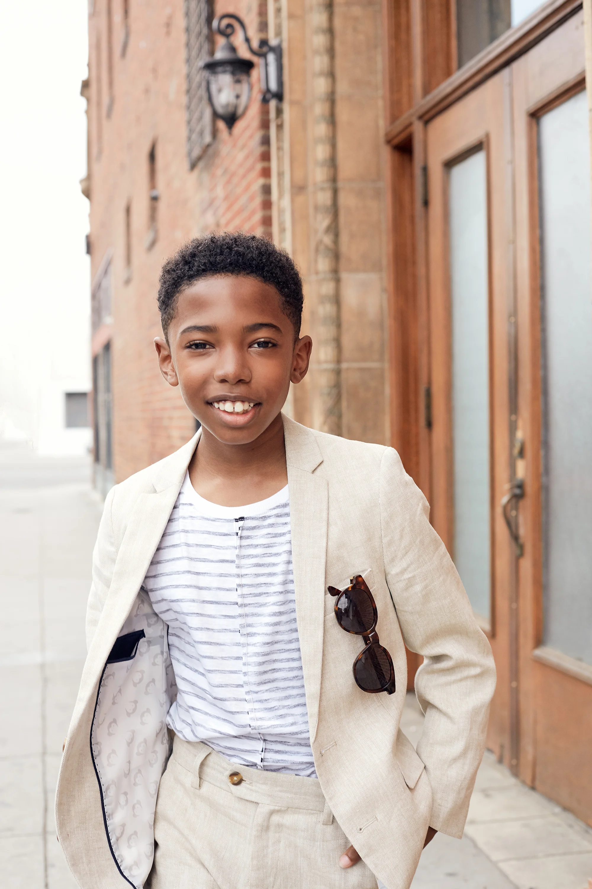 Seth Carr for Posh Kids Magazine Suit: Appaman T-shirt: Stem Loafers: Florsheim Sunglasses: Retrosuperfuture Wardrobe - Angelique Fortuna Grooming - Renee Loiz Photograph - Ryan Pavlovich