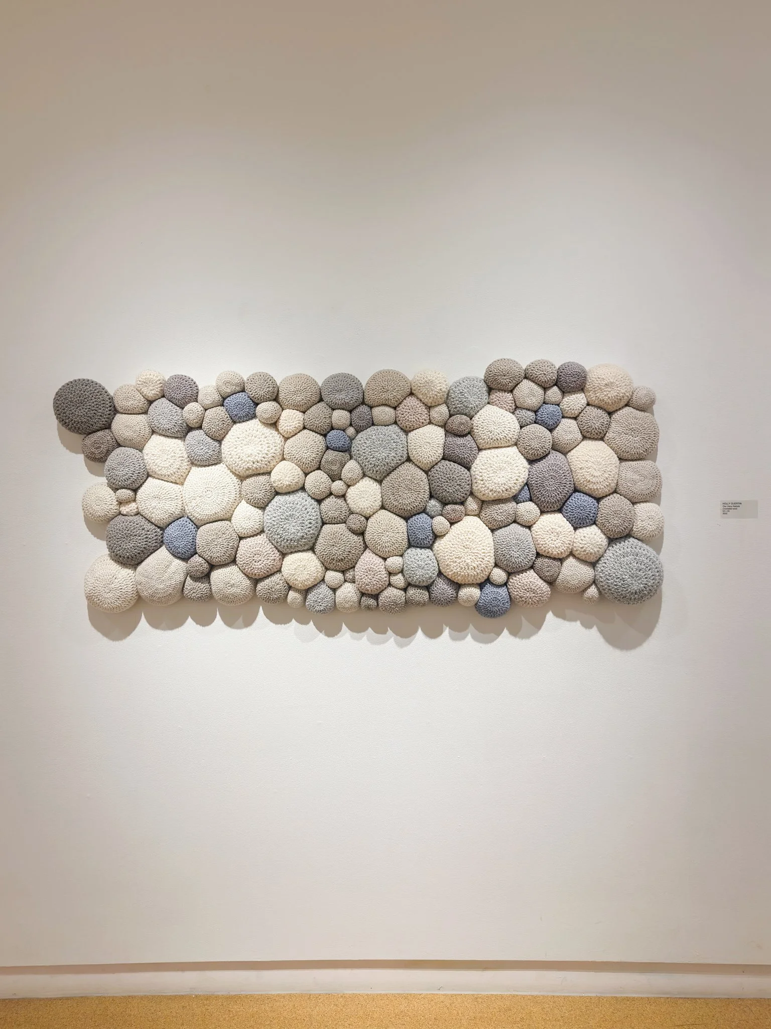 Our Very Nature, 2022, crocheted wool yarn, wool fill, cotton fabric backing, 29”h x 65”w x 4”d