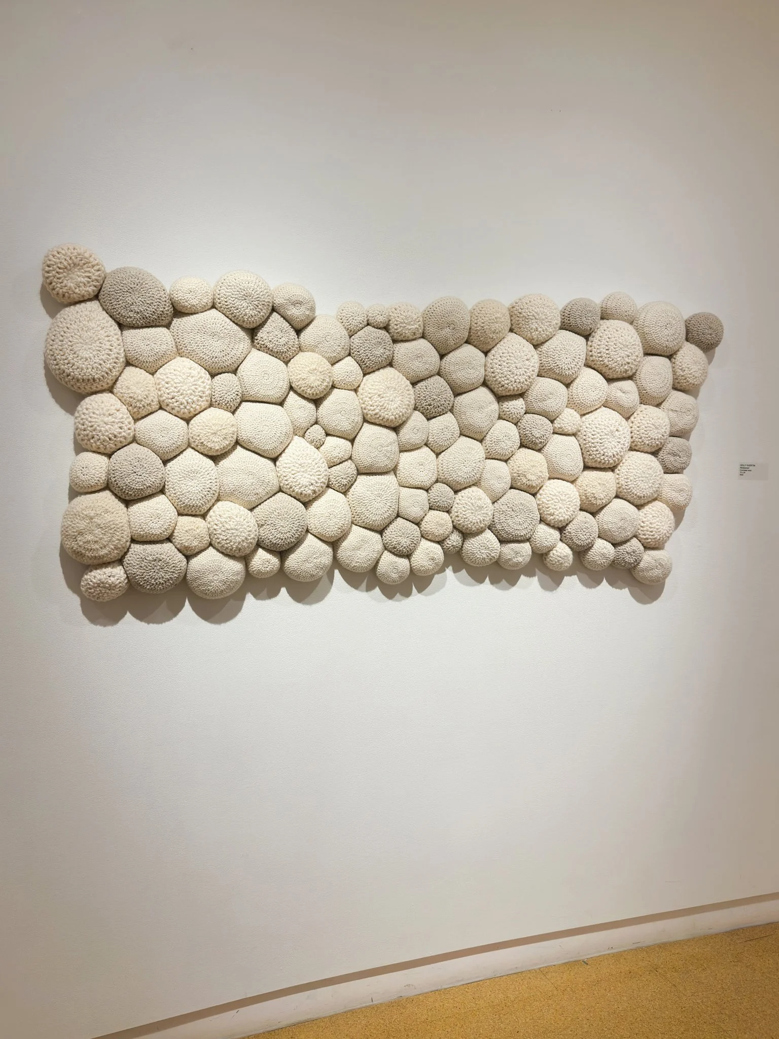 Redeemed, 2022, crocheted wool yarn, wool fill, reclaimed cotton domestic fabric backing, 29”h x 70”w x 4”d