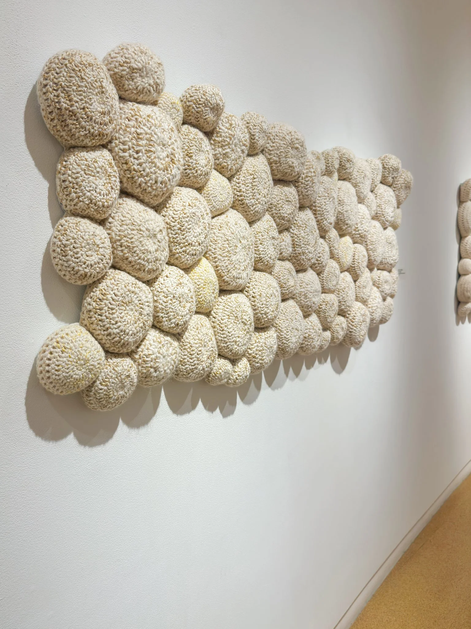 The Intimacy, 2022, crocheted wool yarn, wool fill, reclaimed cotton domestic fabric backing, 28”h x 65”w x 4”d