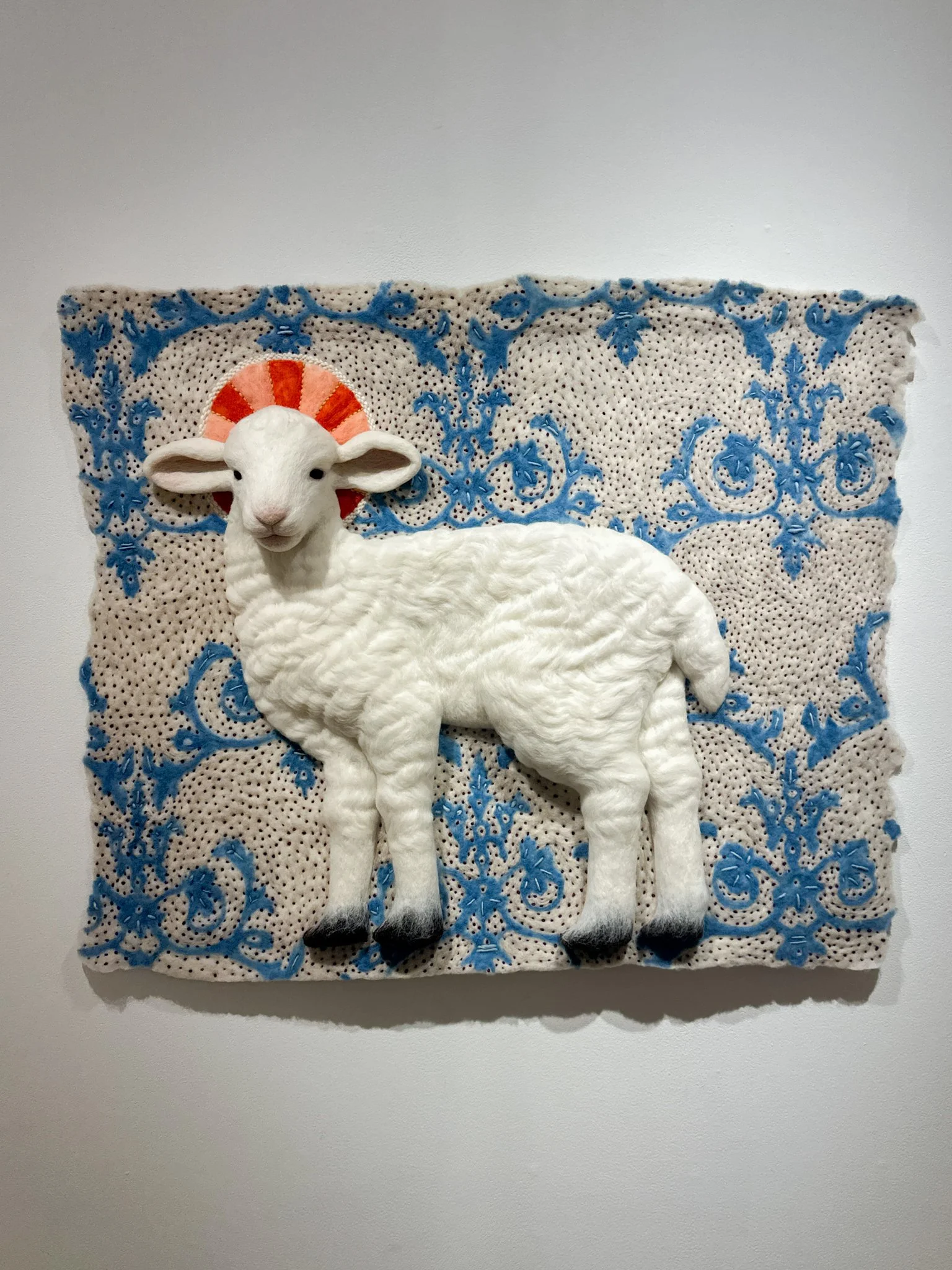 Lamb of God, wool felt with wool embroidery, 32”h x 39”w x 4”d