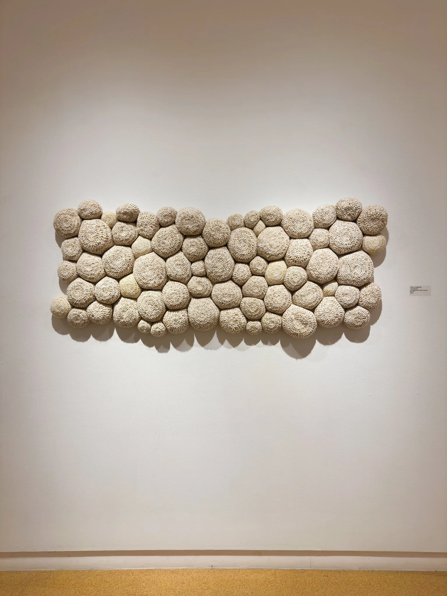 "The Intimacy," 2022, crocheted wool and silk yarn, Kevlar fiber, wool fill, reclaimed cotton domestic fabric backing, 28”h x 65”w x 4”d