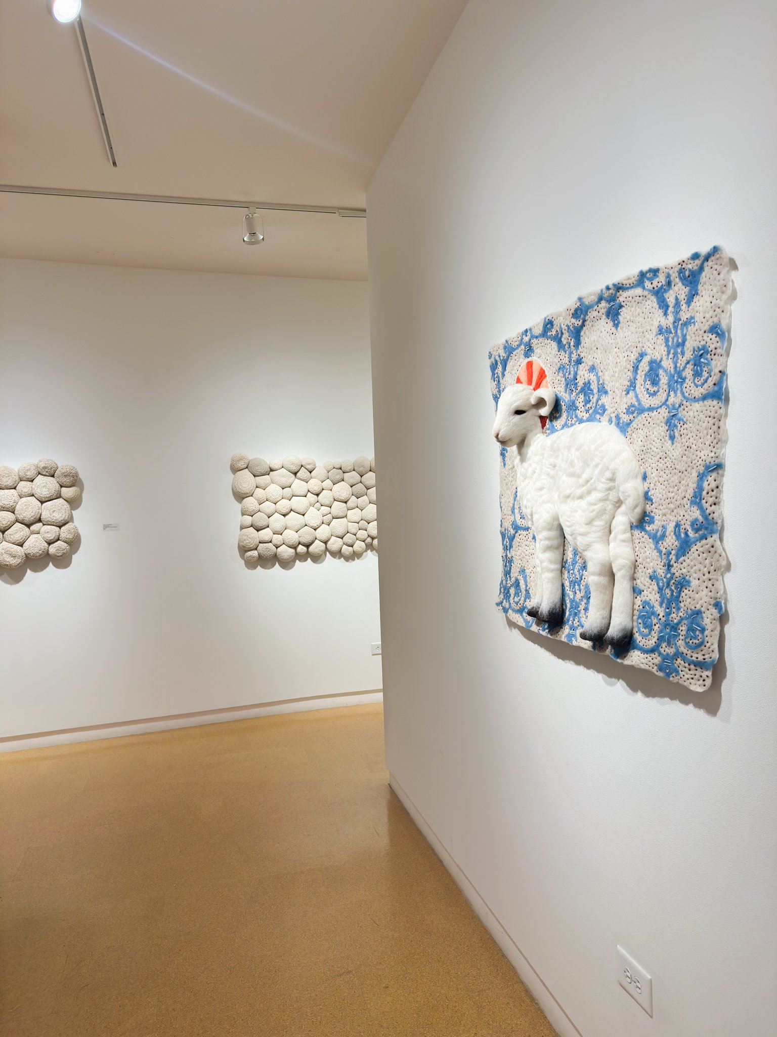 Lamb of God, wool felt with wool embroidery, 32”h x 39”w x 4”d (in situ)
